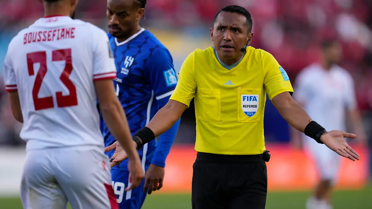 Referee Ivan Barton gestures during the FIFA Club World Cup second round soccer match between Wydad AC and Al Hilal SFC at Prince Moulay Abdellah stadium in Rabat, Morocco, Saturday, Feb. 4, 2023. (AP Photo/Manu Fernandez)