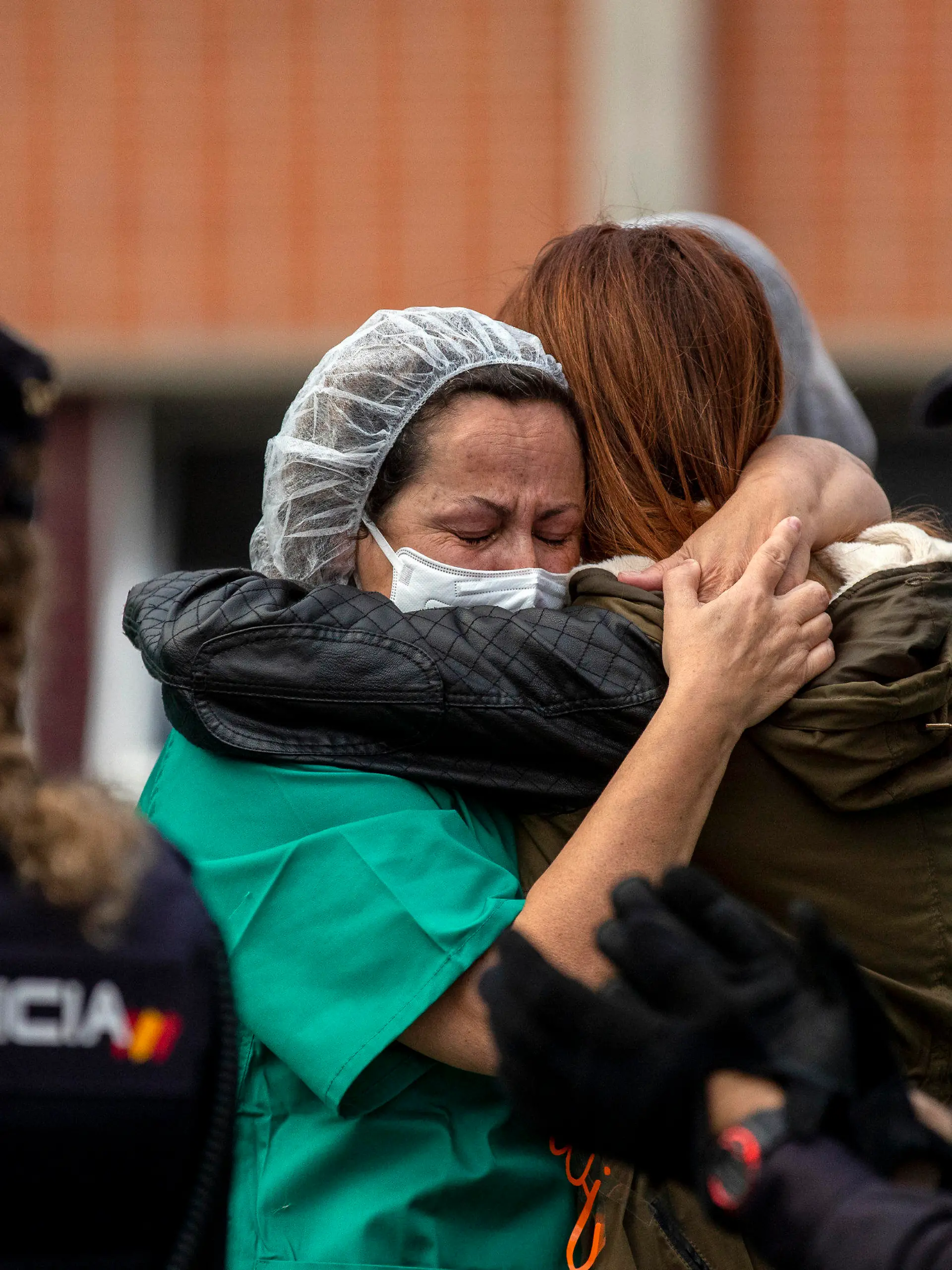 Health workers cry during a memorial for their co-worker Esteban, a male nurse that died of the coronavirus disease, at the Severo Ochoa Hospital in Leganes in Leganes, Spain, Friday, April 10, 2020. The new coronavirus causes mild or moderate symptoms for most people, but for some, especially older adults and people with existing health problems, it can cause more severe illness or death. (AP Photo/Manu Fernandez)