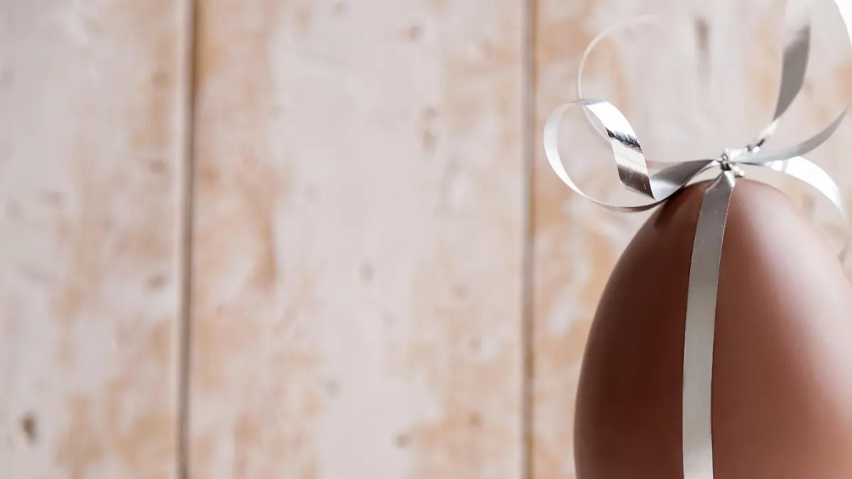 Delicious seasonal chocolate Easter egg with a ribbon