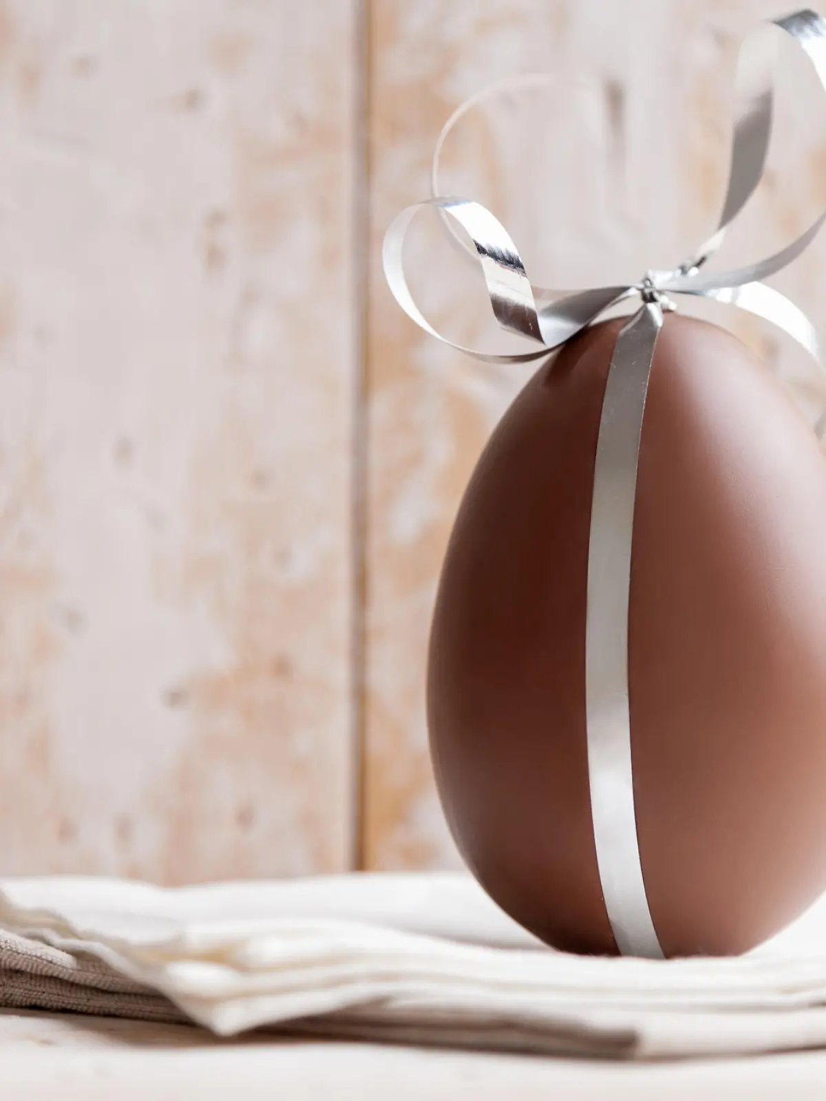 Delicious seasonal chocolate Easter egg with a ribbon