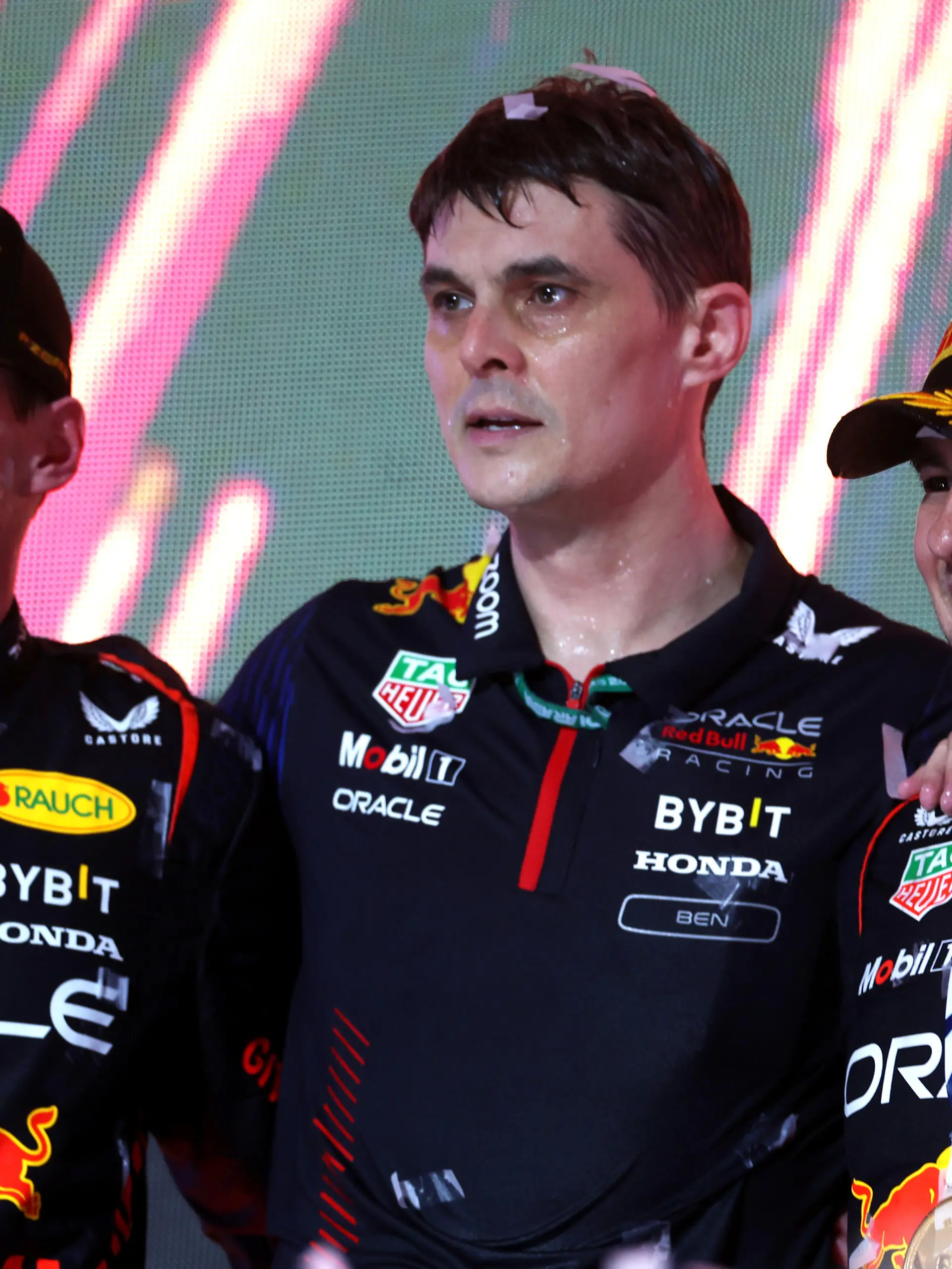JEDDAH, SAUDI ARABIA - MARCH 19: Race winner Sergio Perez of Mexico and Oracle Red Bull Racing (R), Second placed Max Verstappen of the Netherlands and Oracle Red Bull Racing (L) and Ben Waterhouse, Head of Performance Engineering at Red Bull Racing, celebrate on the podium during the F1 Grand Prix of Saudi Arabia at Jeddah Corniche Circuit on March 19, 2023 in Jeddah, Saudi Arabia. (Photo by Lars Baron/Getty Images)
