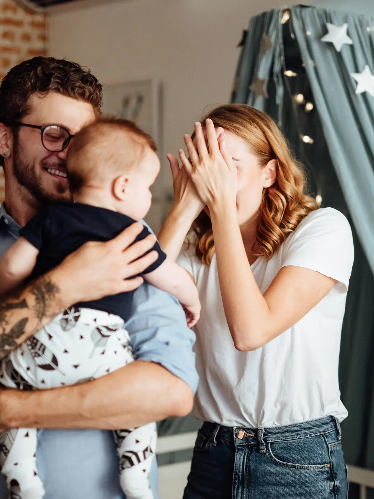 Eltern spielen das Versteckspiel mit dem Baby