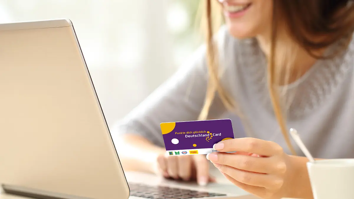 Close up of a happy woman hand buying online with a laptop and paying with a credit card