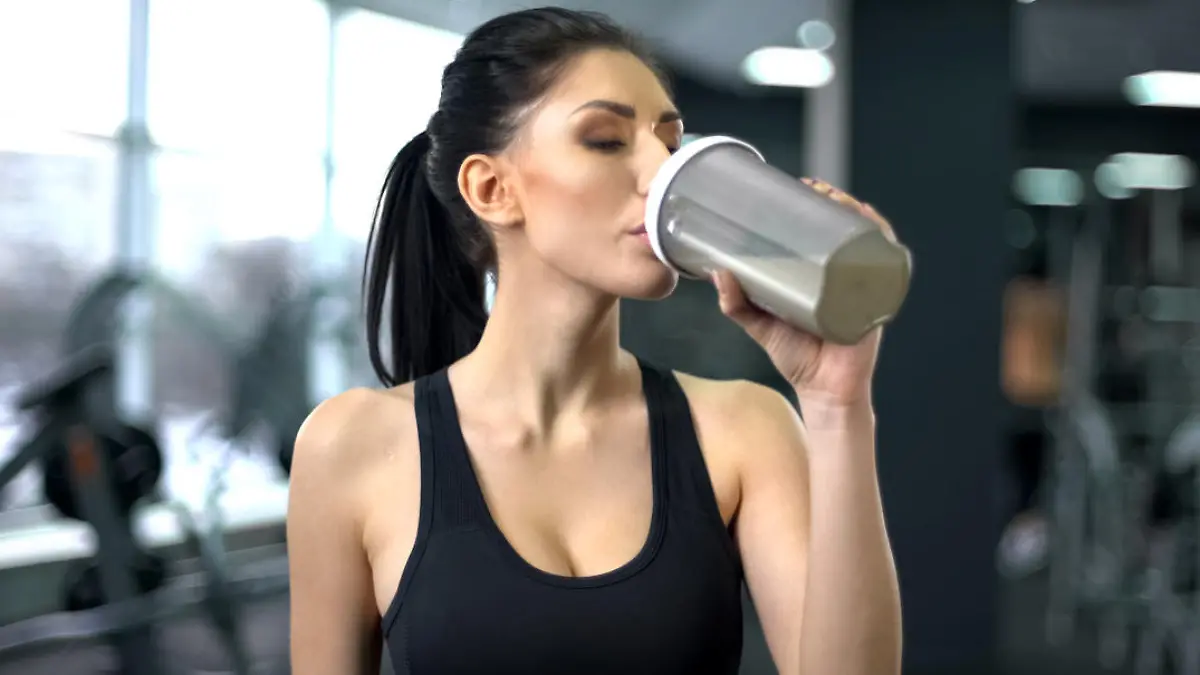 Frau trinkt Proteinpulver