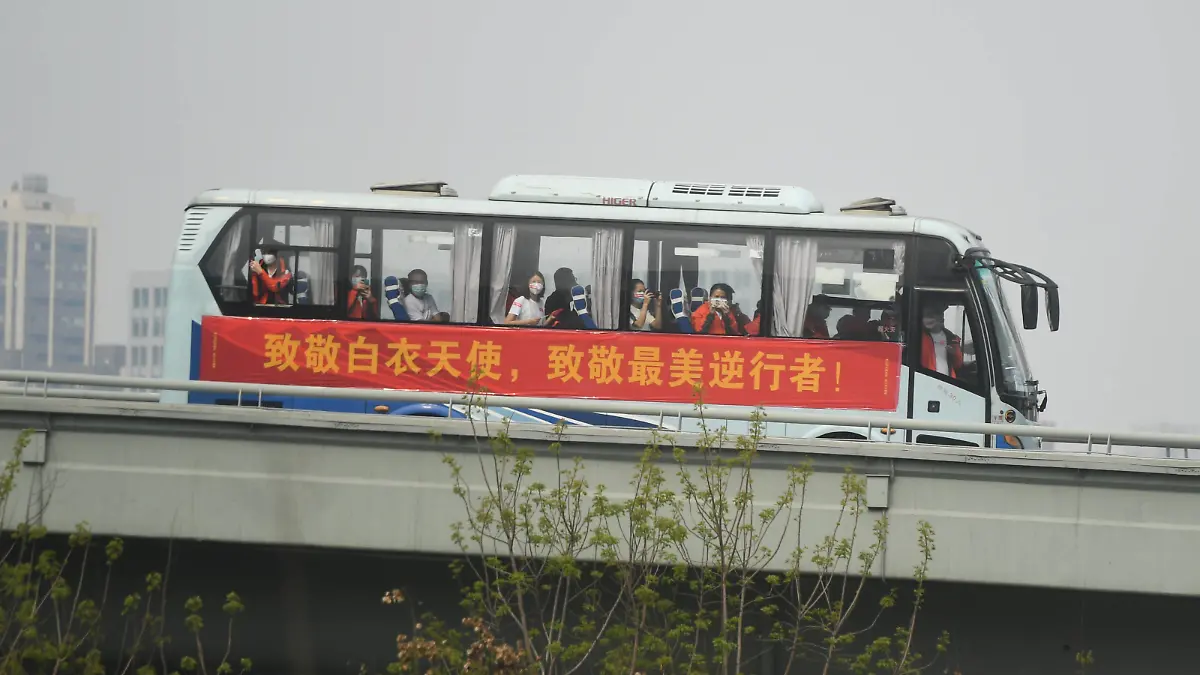  200323 -- WUHAN, March 23, 2020 -- Medics from Guangdong Province take a bus to the airport in Wuhan, central China s Hubei Province, March 23, 2020. A total of 322 members of a medical assistance team from Guangdong Province left Wuhan of Hubei Province on Monday after finishing their task.  CHINA-HUBEI-WUHAN-MEDICAL STAFF FROM GUANGDONG-DEPARTURE CN ChenxYehua PUBLICATIONxNOTxINxCHN