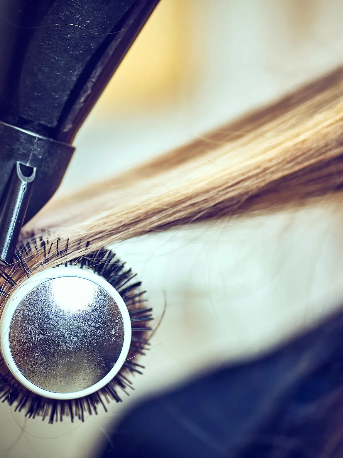Professional hairdresser drying hair, in ctudio