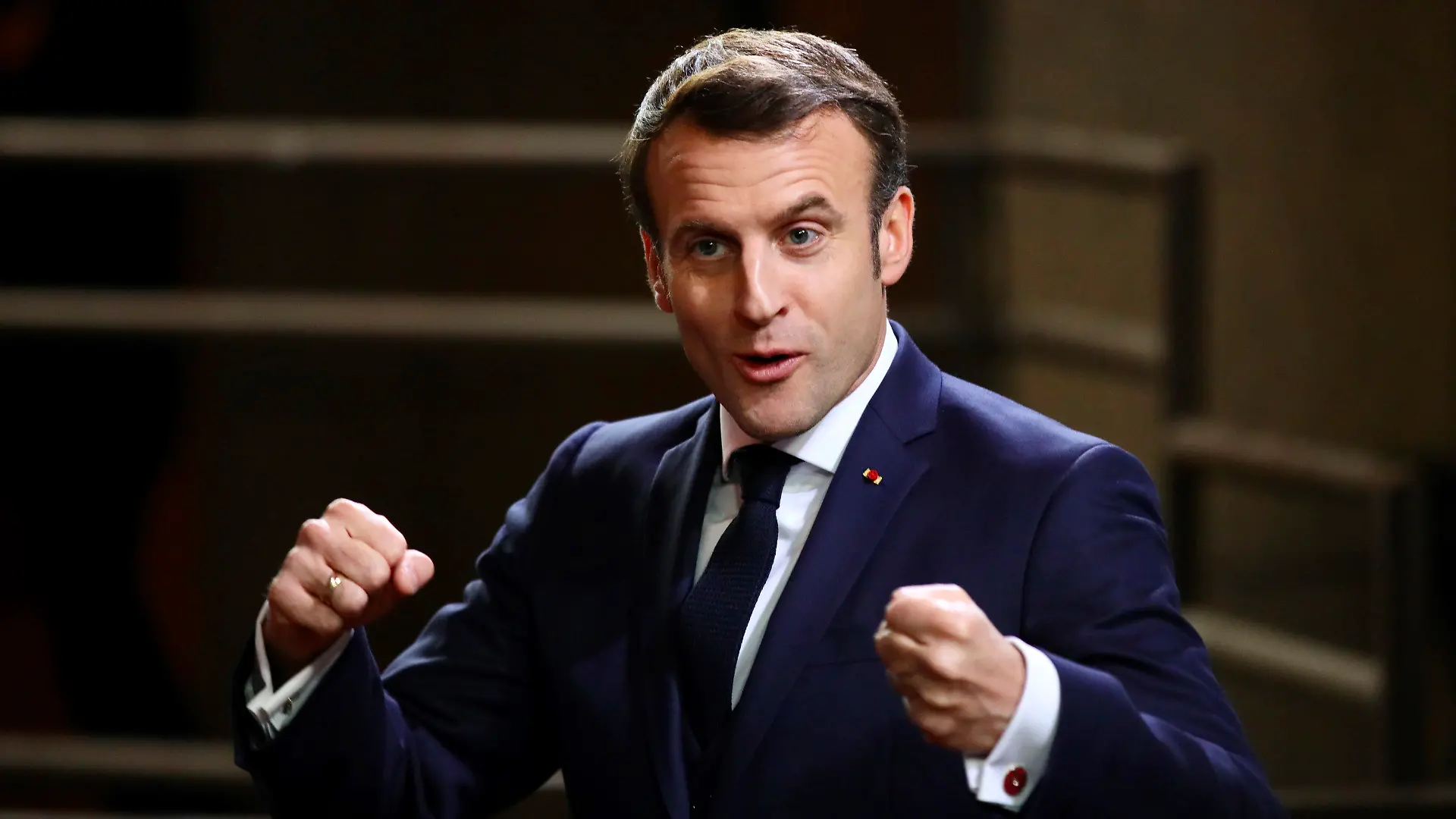 French President Emmanuel Macron speaks with the media as he departs at the end of an EU summit in Brussels, Friday, Feb. 21, 2020. Major contributors to the European Union's budget blocked progress at an emergency summit on Friday, insisting that they would not stump up more funds for the bloc's next long-term spending package. (AP Photo/Olivier Matthys)