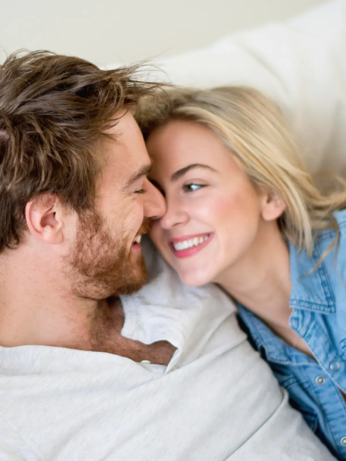 Loving couple relaxing at home lying on the sofa - relationship concepts 