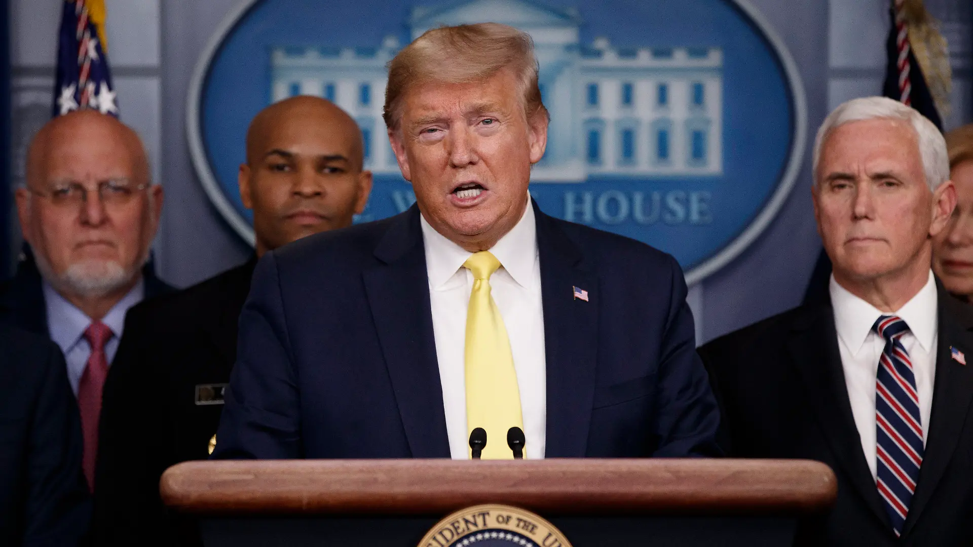 In this March 9, 2020, photo, President Donald Trump speaks in the briefing room of the White House in Washington about the coronavirus outbreak as Dr. Robert Redfield, director of the Centers for Disease Control and Prevention, Surgeon General Jerome Adams and Vice President Mike Pence, listen. (AP Photo/Carolyn Kaster, File)