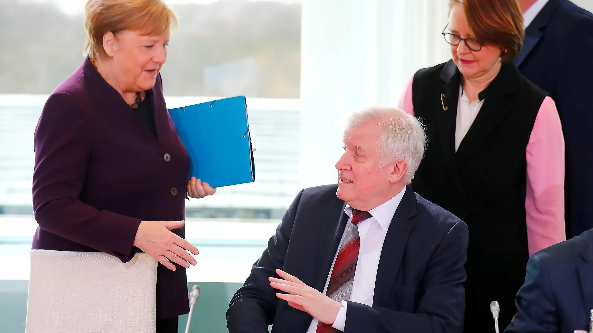 German Interior Minister Horst Seehofer refuses to shake the hand of German Chancellor Angela Merkel for hygienic reasons before a migration summit at the Chancellery in Berlin, Germany, March 2, 2020. REUTERS/Hannibal Hanschke TPX IMAGES OF THE DAY