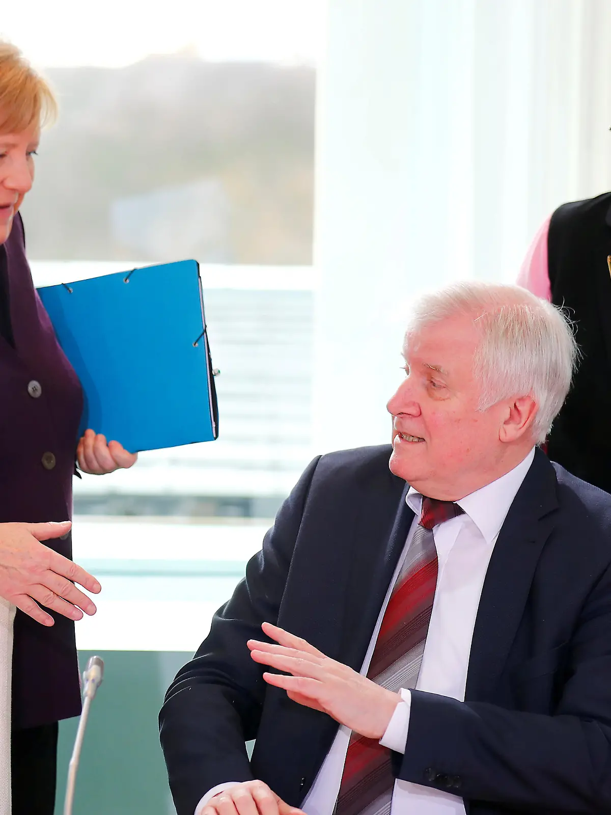 German Interior Minister Horst Seehofer refuses to shake the hand of German Chancellor Angela Merkel for hygienic reasons before a migration summit at the Chancellery in Berlin, Germany, March 2, 2020. REUTERS/Hannibal Hanschke     TPX IMAGES OF THE DAY