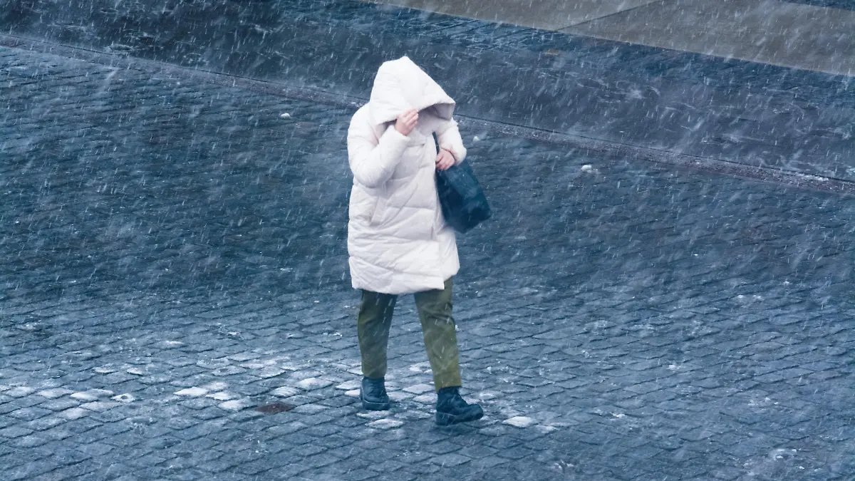 A general view of a woman walking during the snowy weather in Cologne, Germany on March 8, 2023 (Photo by Ying Tang/NurPhoto)