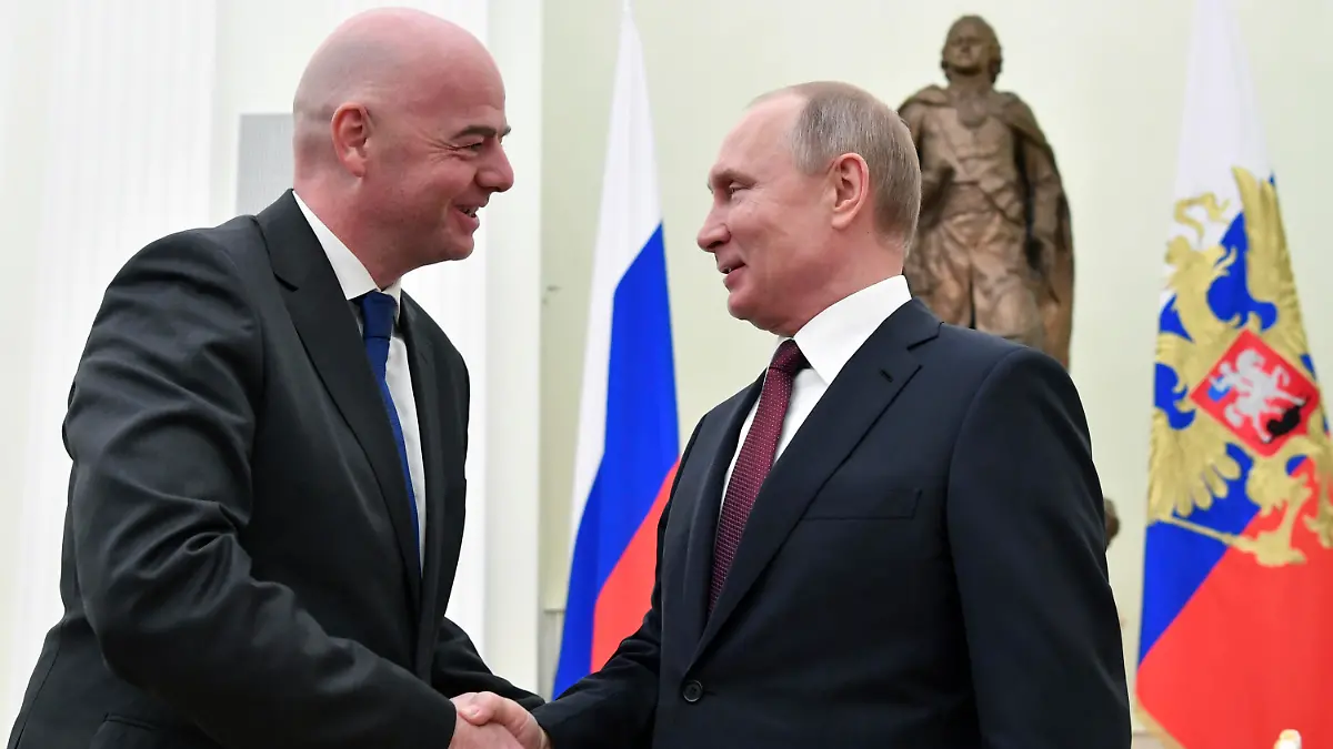 Russian President Vladimir Putin, right, and FIFA President Gianni Infantino greet each other during a meeting in the Kremlin in Moscow, Russia, Wednesday, Feb. 20, 2019. (Yuri Kadobnov/Pool Photo via AP)