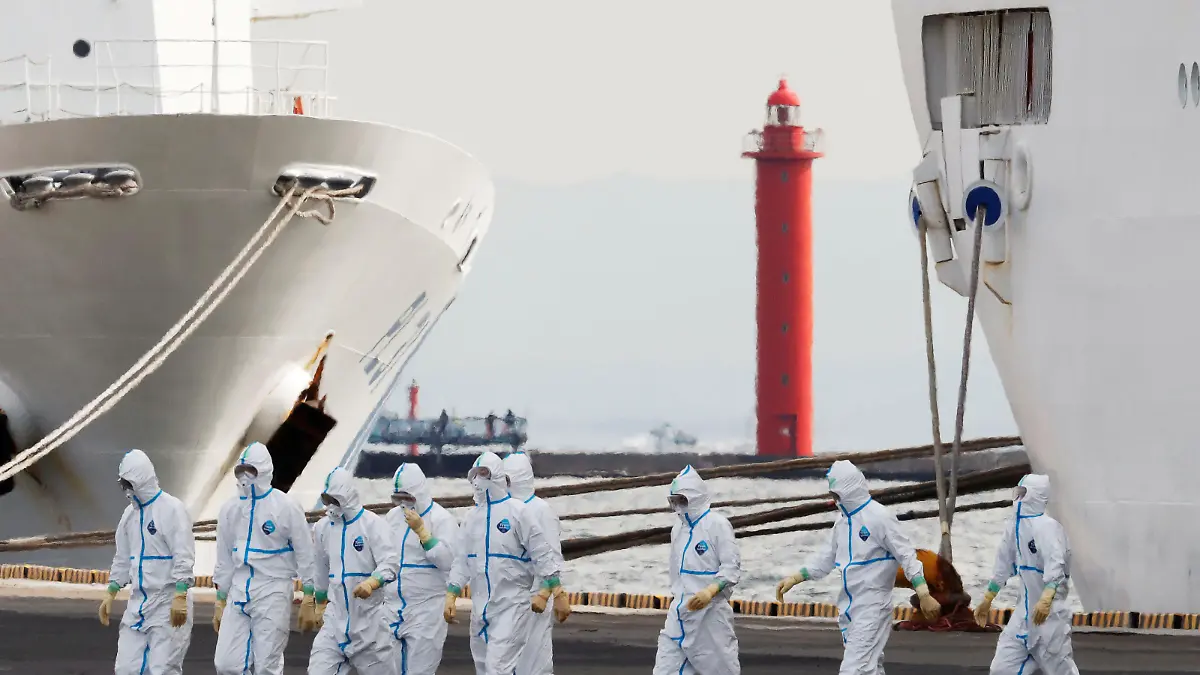 Men wearing protective gear are seen near the cruise ship Diamond Princess, where 10 more people were tested positive for coronavirus on Thursday, at Daikoku Pier Cruise Terminal in Yokohama, south of Tokyo, Japan February 7, 2020. REUTERS/Kim Kyung-Hoon