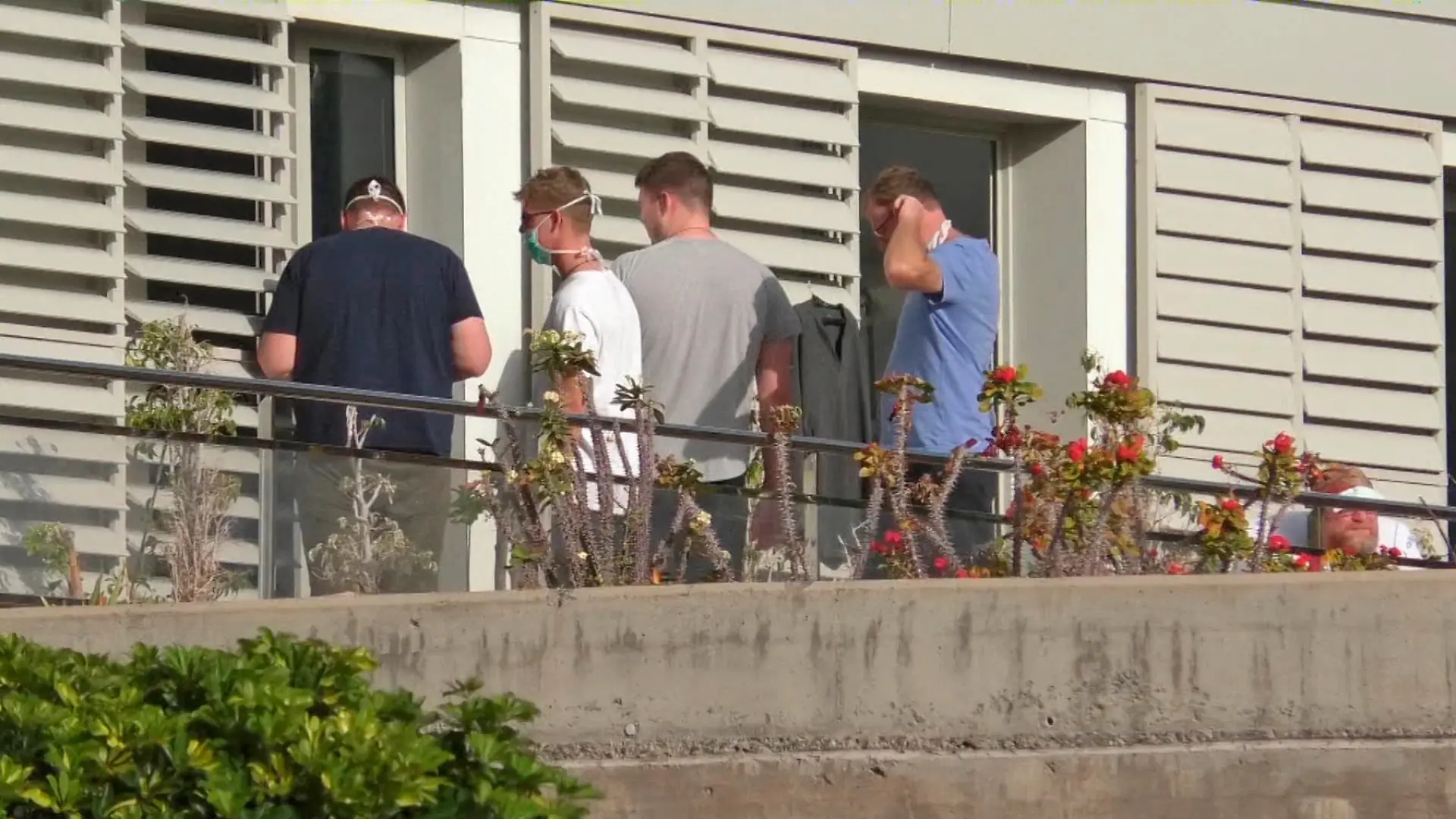 People wearing surgical masks are seen at the balcony of a hospital n the remote Spanish island of La Gomera, where the first case of coronavirus in the country has been confirmed, January 31, 2020. Acfi Press/via REUTERS ATTENTION EDITORS - SPAIN OUT.