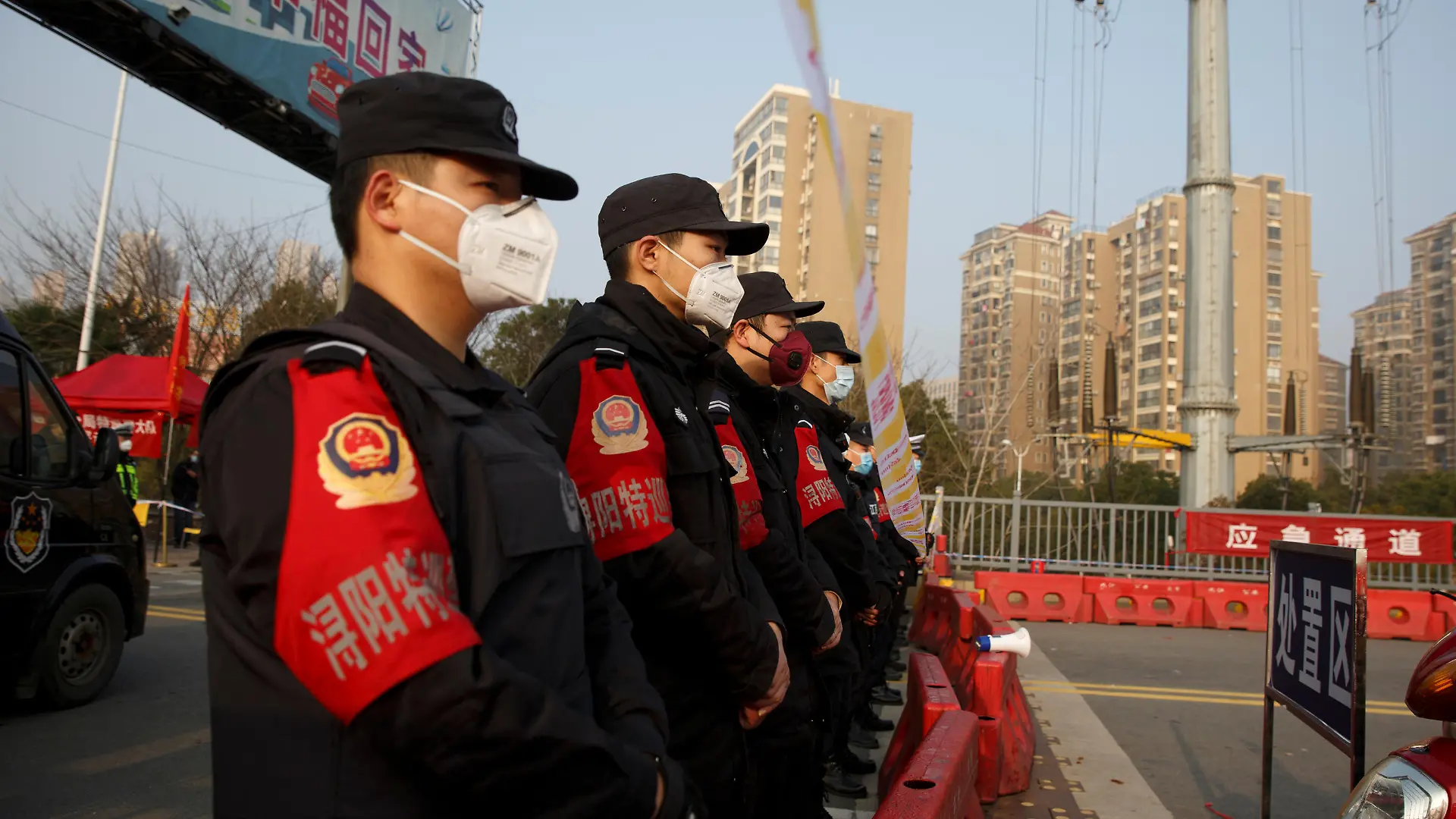 Police stand at a checkpoint at the Jiujiang Yangtze River Bridge that crosses from Hubei province in Jiujiang, Jiangxi province, China, as the country is hit by an outbreak of a new coronavirus, January 31, 2020. Police and security personnel lined up in a formation at the checkpoint after the local propaganda department granted access to foreign media. REUTERS/Thomas Peter