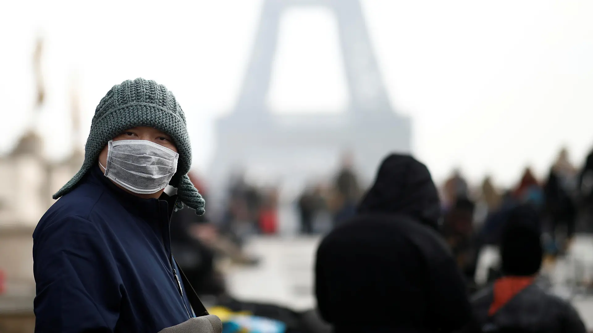 A man wears a face mask on the Trocadero esplanade in front of the Eiffel Tower in Paris, France, January 25, 2020, as France confirmed three cases of the new coronavirus. REUTERS/Benoit Tessier