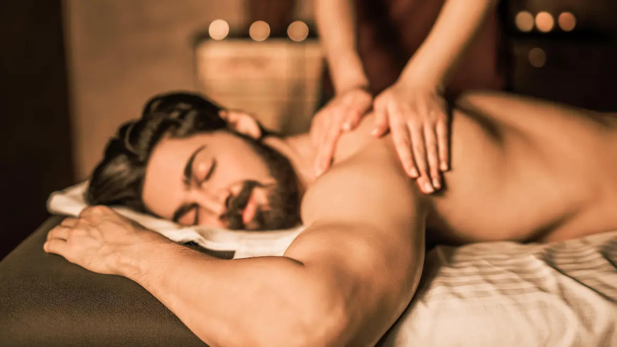 Relaxed mid adult man enjoying a back massage.