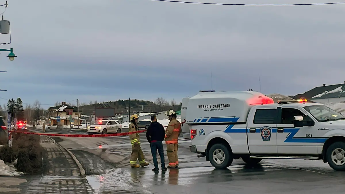 In this image provided by CTV News, first responders work the scene where two men died after a pickup truck plowed into pedestrians who were walking beside a road in Amqui, Quebec, Monday, March 13, 2023. (CTV News via AP)