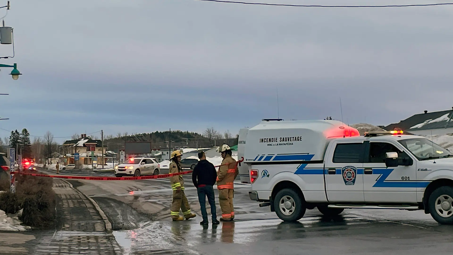In this image provided by CTV News, first responders work the scene where two men died after a pickup truck plowed into pedestrians who were walking beside a road in Amqui, Quebec, Monday, March 13, 2023. (CTV News via AP)