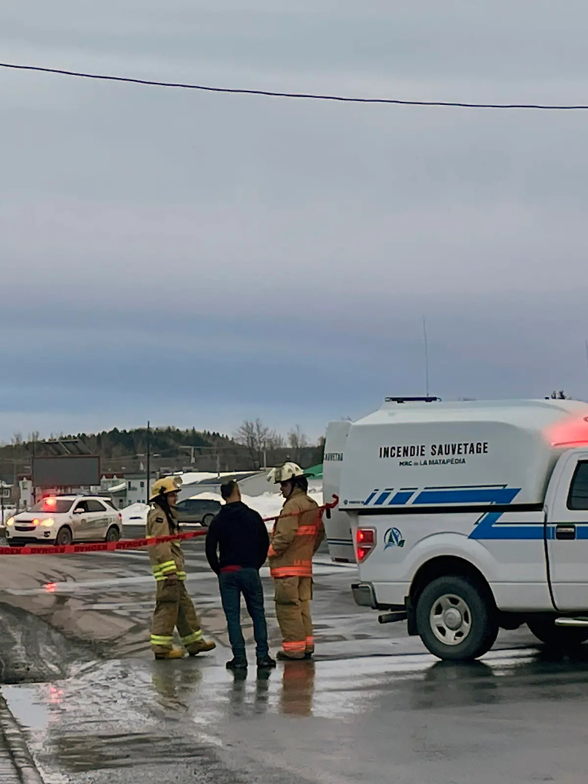 In this image provided by CTV News, first responders work the scene where two men died after a pickup truck plowed into pedestrians who were walking beside a road in Amqui, Quebec, Monday, March 13, 2023. (CTV News via AP)