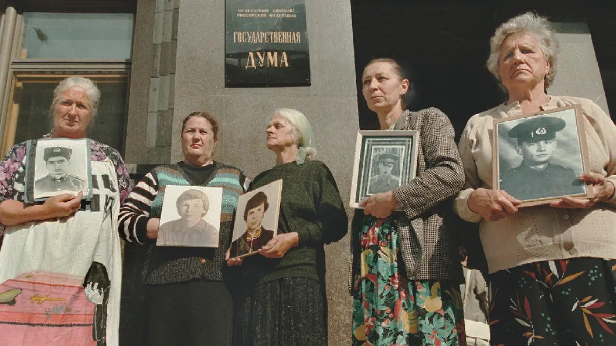 The mothers of soldiers killed during service in the Russian army stand at the entrance of the Russian State Duma carrying portraits of their sons, 19 July. The picket against the deaths during the peace time in Russian Army was organized by the "Soldiers' Mothers committee". - COLORplus -