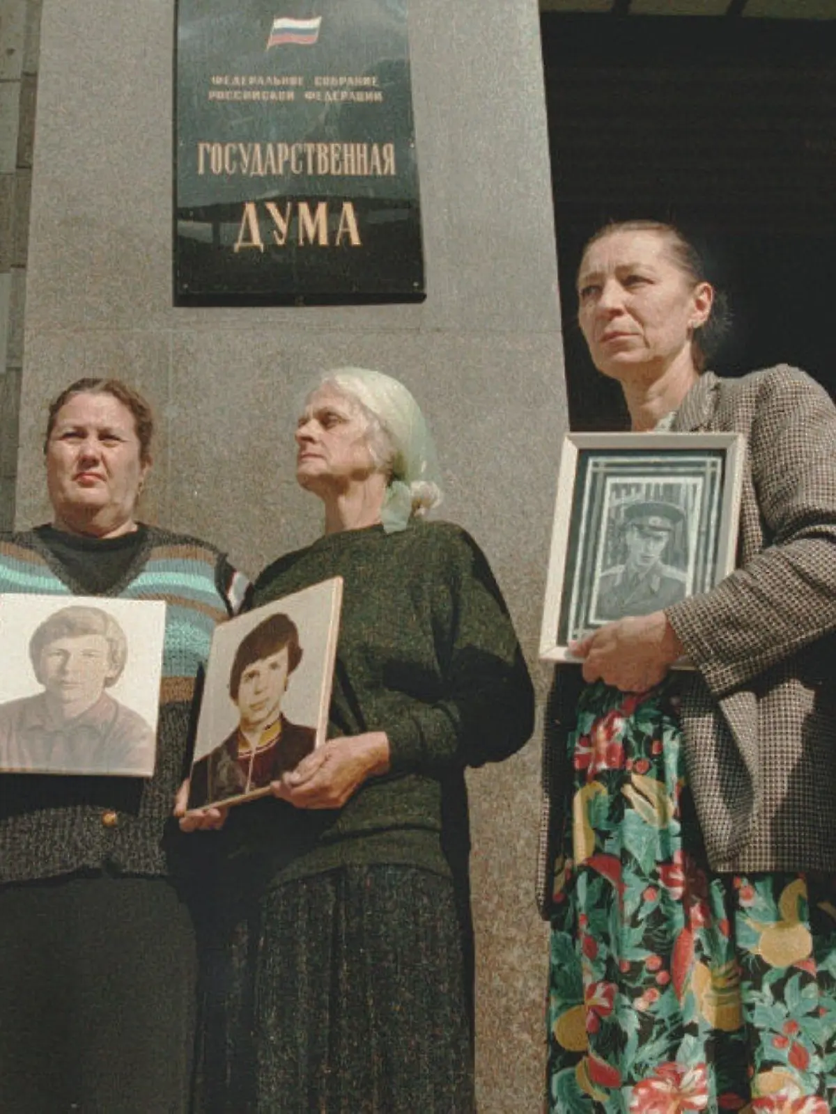The mothers of soldiers killed during service in the Russian army stand at the entrance of the Russian State Duma carrying portraits of their sons, 19 July. The picket against the deaths during the peace time in Russian Army was organized by the "Soldiers' Mothers committee". - COLORplus -