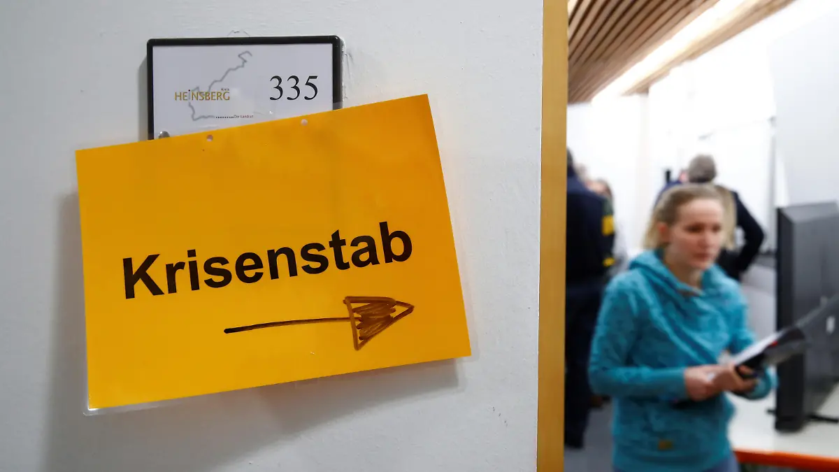 A woman leaves a session of the coronavirus crisis management group "Krisenstab" of the western German administrative district of Heinsberg near Aachen, Germany, February 27, 2020, after several positive cases of coronavirus were found in the district. REUTERS/Wolfgang Rattay