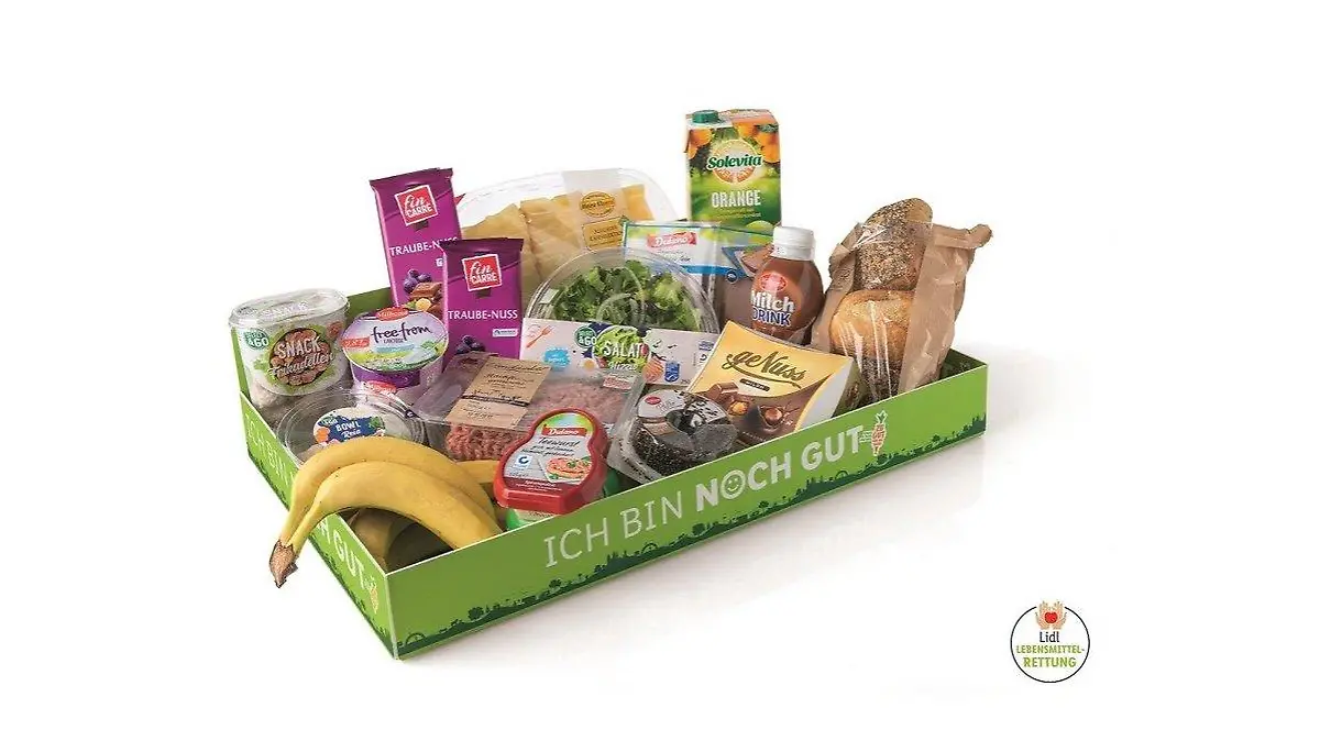 Flache, grüne Pappbox mit der Aufschrift: Ich bin noch gut. Pappbox enthält Bananen, Joghurt, Brötchen und Schokolade.