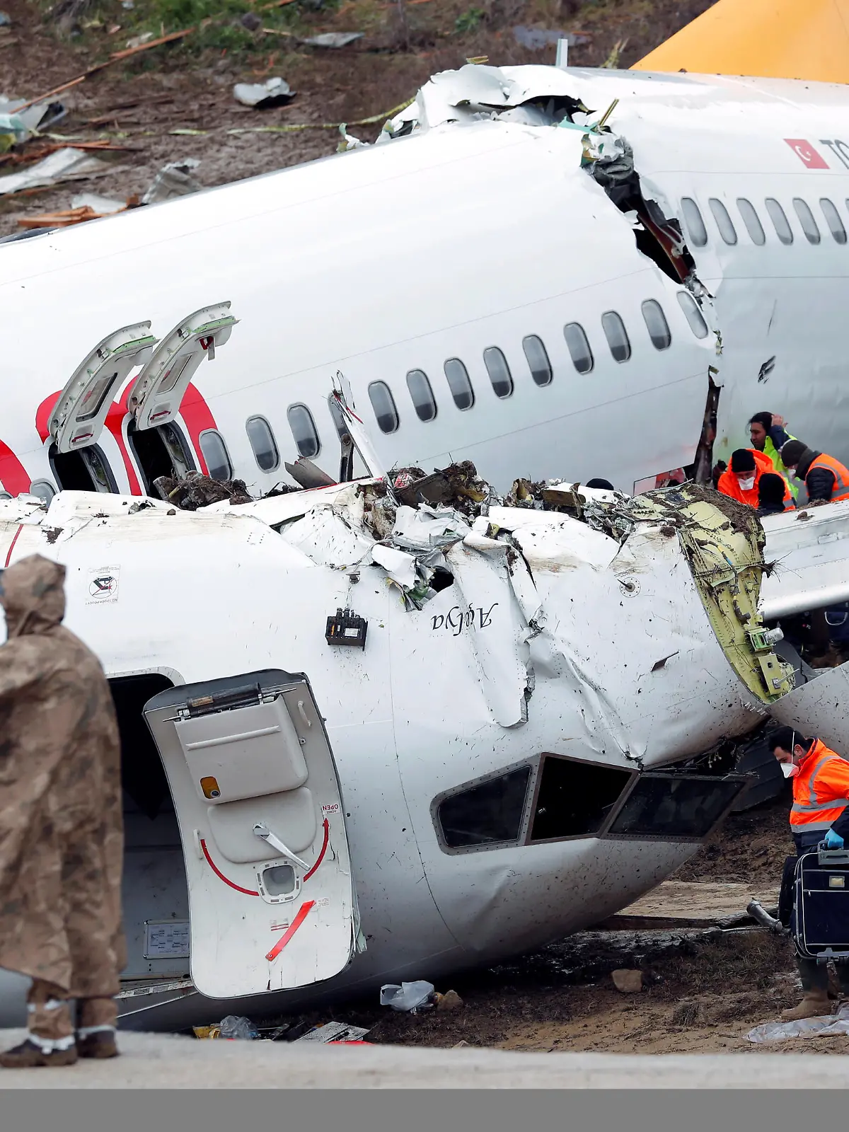 People work at the Pegasus Airlines Boeing 737-86J plane wreckage, after it overran the runway during landing and crashed, at Istanbul's Sabiha Gokcen airport, Turkey February 6, 2020. REUTERS/Murad Sezer