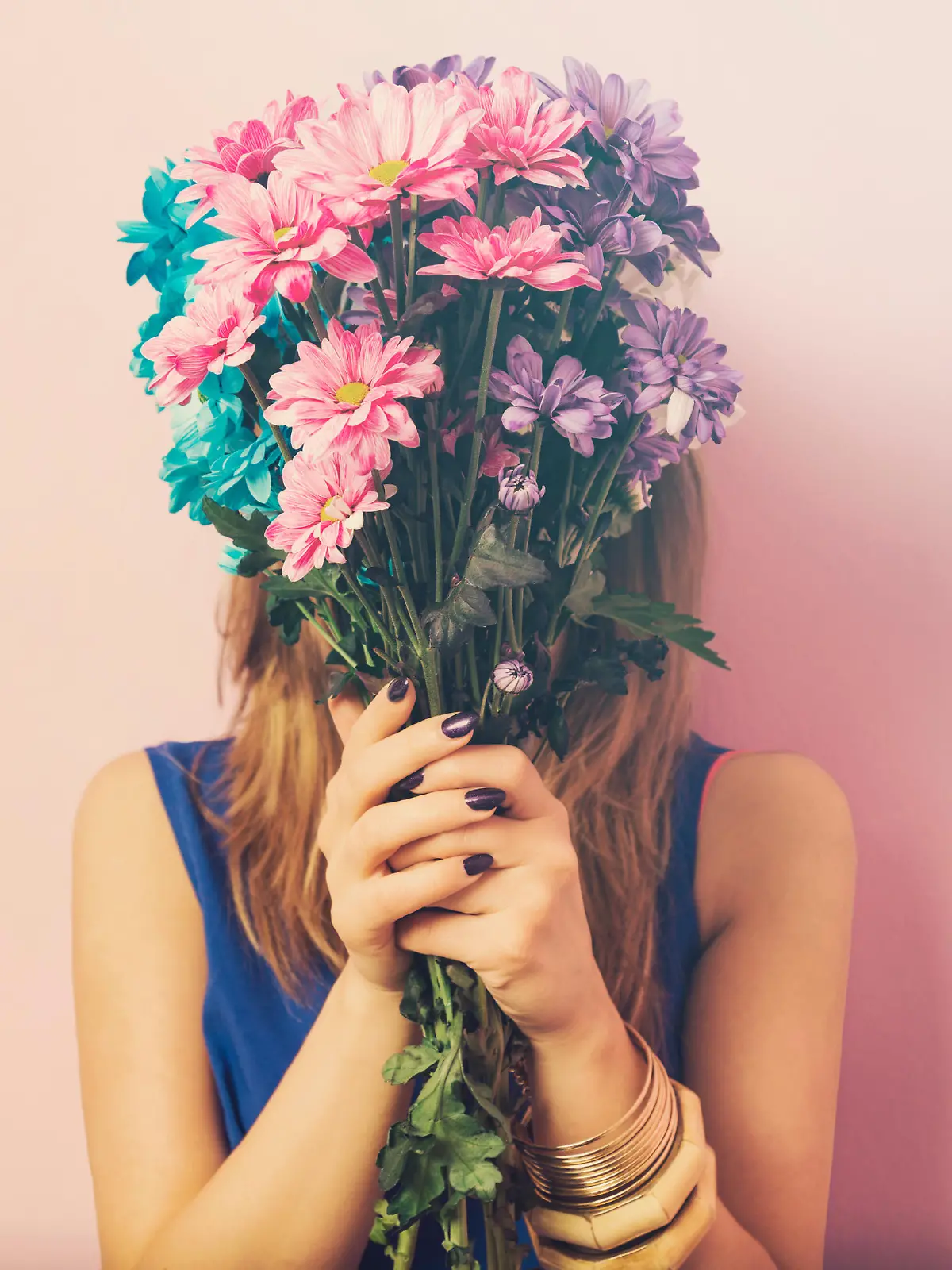 Young attractive beautiful woman smelling flowers.