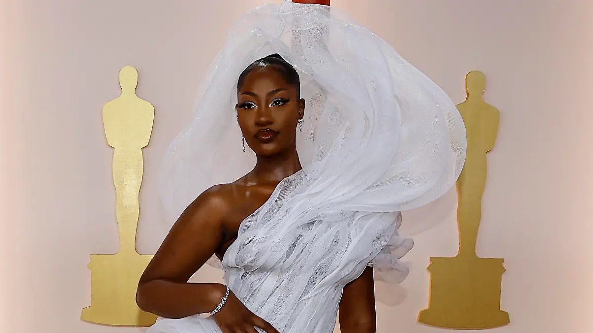Tems poses on the champagne-colored red carpet during the Oscars arrivals at the 95th Academy Awards in Hollywood, Los Angeles, California, U.S., March 12, 2023. REUTERS/Eric Gaillard