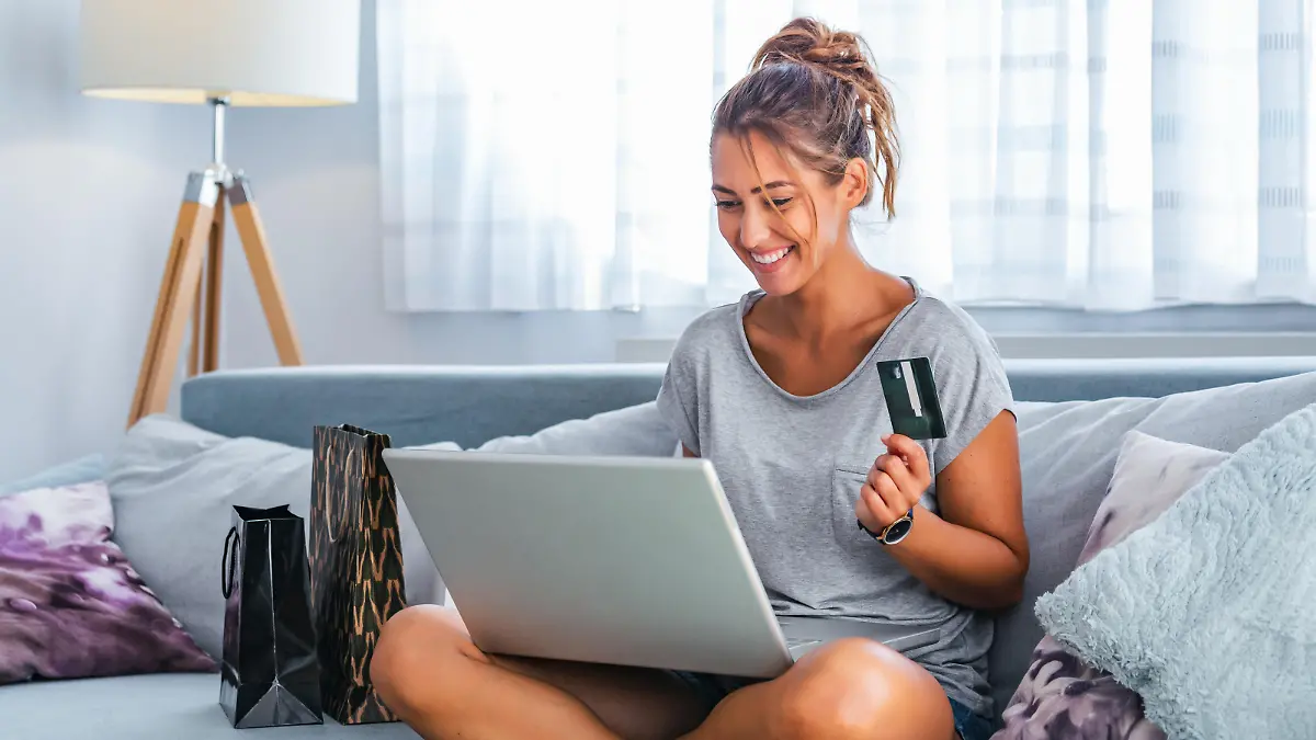 Picture showing pretty woman shopping online with credit card. woman holding credit card and using laptop. Online shopping concept