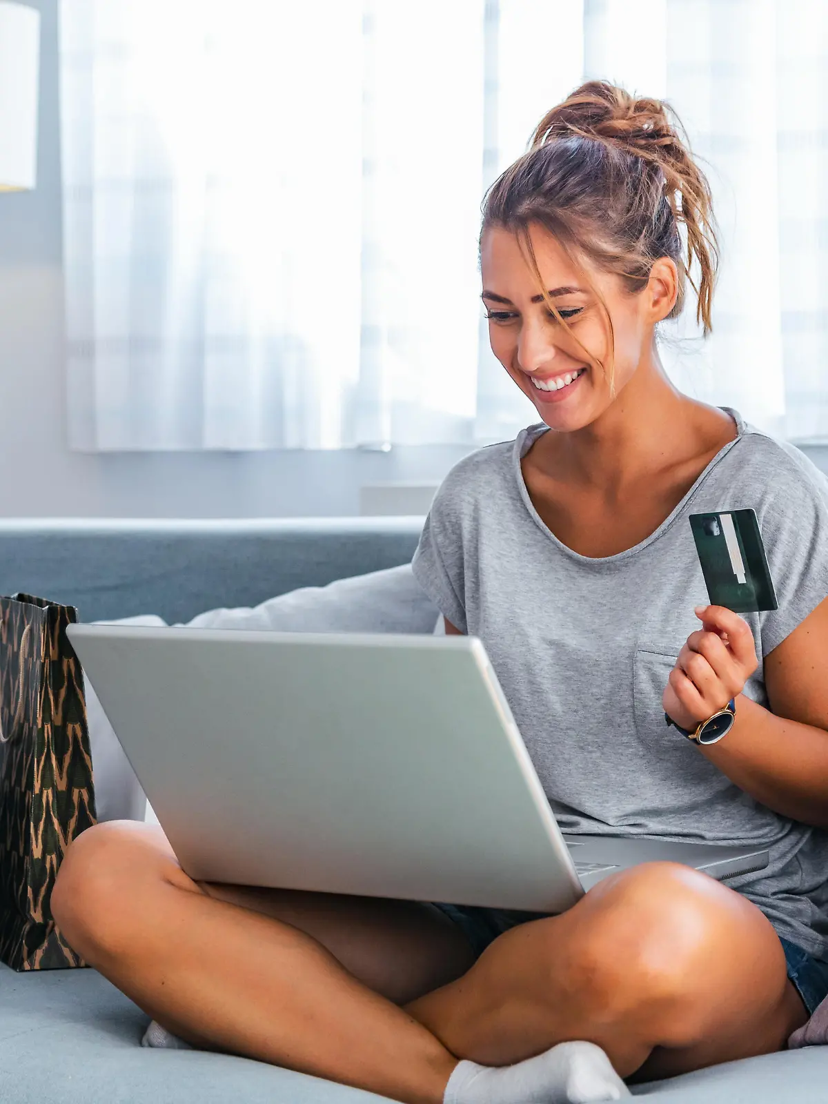 Picture showing pretty woman shopping online with credit card. woman holding credit card and using laptop. Online shopping concept