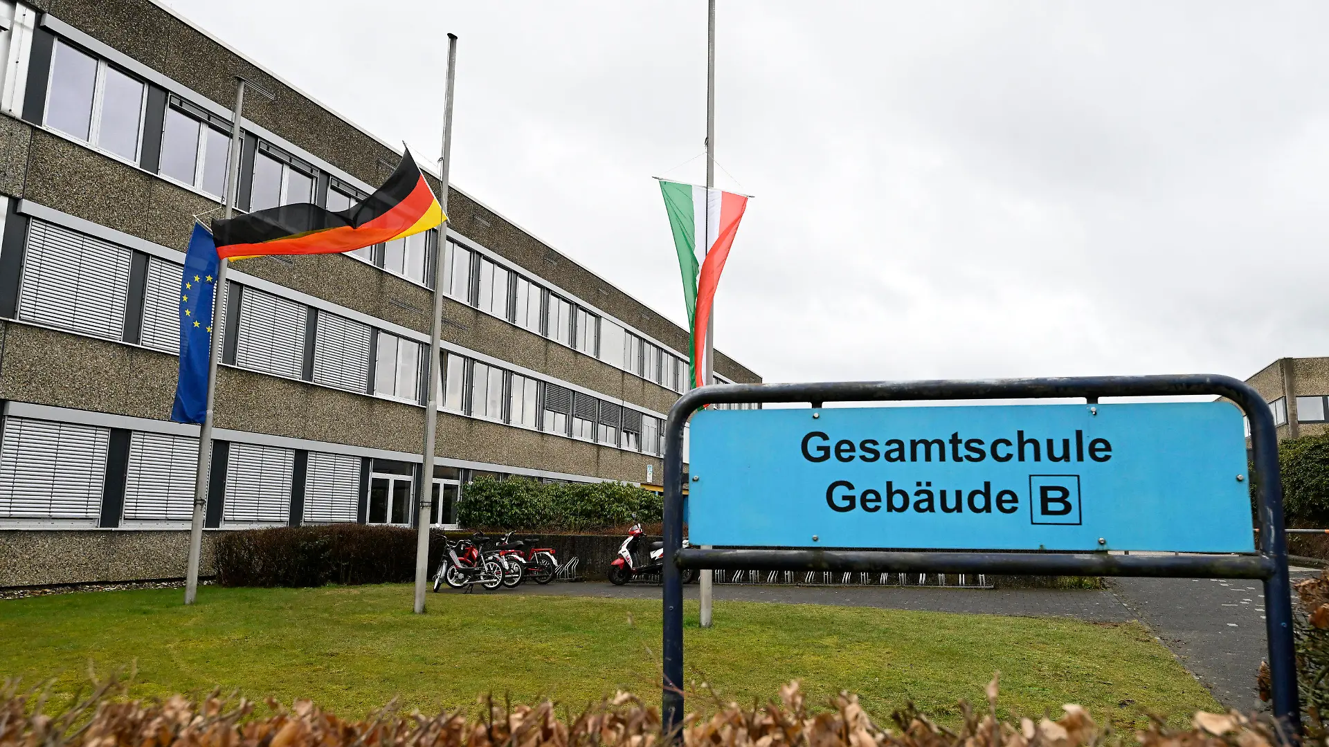 13.03.2023, Nordrhein-Westfalen, Freudenberg: Blick auf das Schulzentrum des ermordeten Mädchens. Die Schule hat geöffnet, die Fahnen sind auf Halbmast geflaggt und die Schüler werden von Therapeuten begleitet. In einem Waldstück wurde gestern die Leiche eines 12-jährigen Mädchens gefunden. Das Mädchen wurde am Samstag vermisst und die Polizei startete eine groß angelegte Suchaktion, bei der die Leiche am Sonntag entdeckt wurde. Foto: Roberto Pfeil/dpa +++ dpa-Bildfunk +++