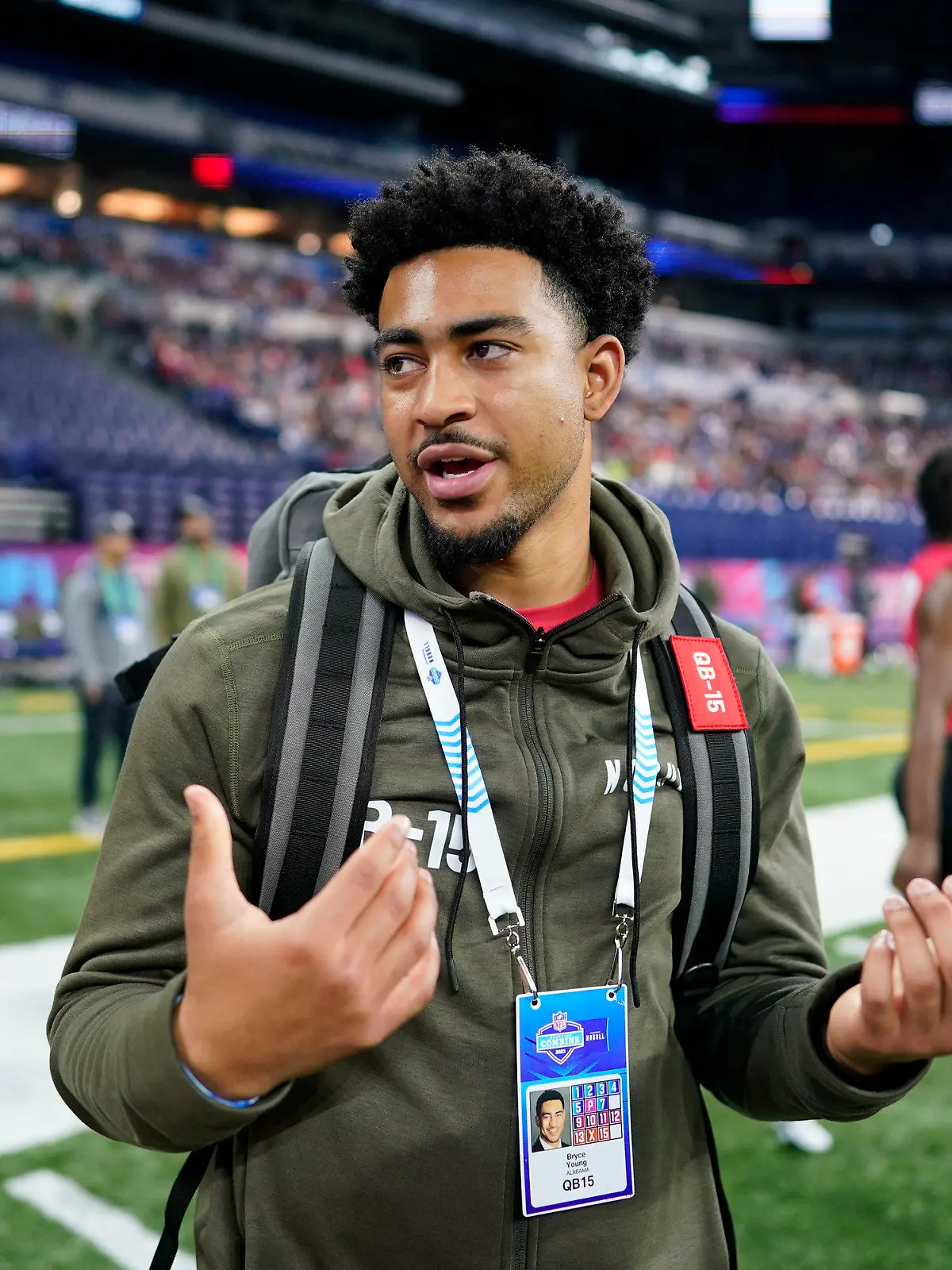 Alabama quarterback Bryce Young talks on the field during the NFL football scouting combine in Indianapolis, Saturday, March 4, 2023. (AP Photo/Darron Cummings)