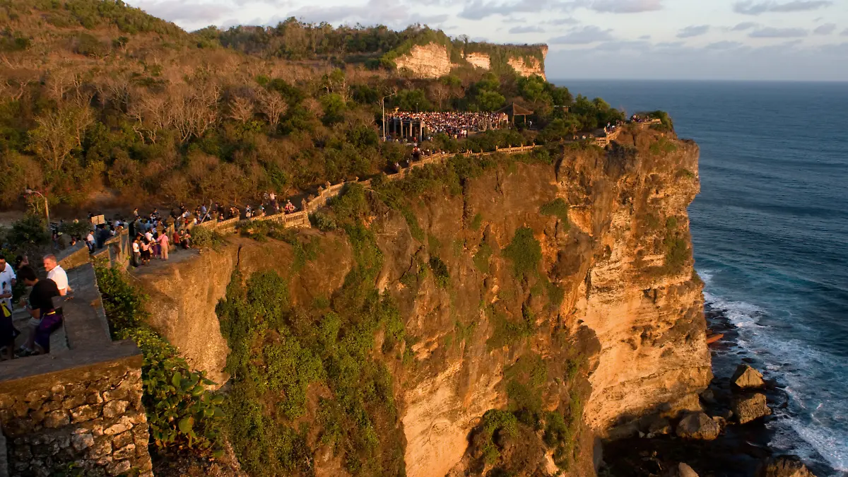 Tourists along the cliffs next to the Ulu Watu temple Pura Luhur. Bali. Uluwatu Temple is a Hindu temple set on the cliff bank in south part of Bali Peninsula. It is one of Sad Kahyangan Temple in Bali (six big groups of Bali Temples), located in Pecatu Village, Sub district of South Kuta, and Badung Regency or about 25 Km southerly part of Denpasar town. It is situated on the coral reef sordid to sea about 80 meters above the sea level. It is featured by a small dry forest which is mostly called by Alas Kekeran (interdict forest) which is belong to the temple and dwelt by a lot of monkeys and other animal. Name of Uluwatu was come from the word Ulu meaning the head and Watu meaning stone. Therefore Uluwatu Temple mean the temple built in tip of coral reef. In the right and left of temple building or Pelinggih Ida Bagus Ratu Jurit located in complex of Uluwatu Temple, there are two stone mangers that look like a boat. When both of it are united, hence it's look similar to sarcophagus, the famous stone from megalithic era culture. There is archaeology omission coming from 16 centuries in firm of arch or winged entrance gate. Winged entrance gate is one of the scarce archaeology omissions. Winged entrance gate that is existing in Uluwatu Temple (a period of its making) can be compared with the same one located in mosque complex in Sendangduwur Village, Lamongan, East Java. The period of its making is relevant with the year Candrasengkala found at this inscription. Candrasengkala founded in the mosque is written by the wording Gunaning Salira Tirta Hayu meaning year 1483 Saka or 1561 Masehi.
If the sarcophagus that existing in Dalem Jurit complex area represents the artifact, hence Uluwatu Temple represents the place sanctified since era of megalithic culture (About 500 S.M). In papyrus of Usana Bali mentioned that Mpu Kuturan (The Hindu Priest who spread out the Hinduism in Bali) had built a lot of temple in this island and one of them Uluwatu Temple. | Verwendung ...