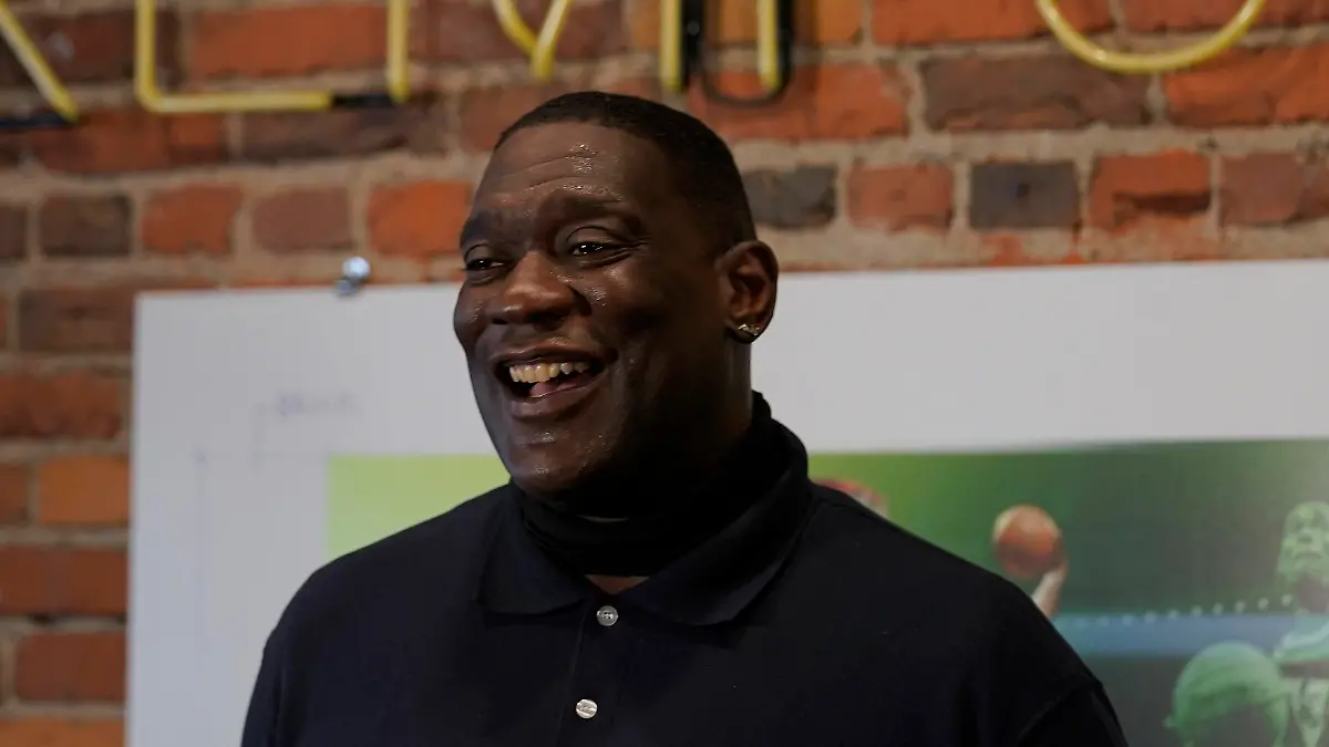 Shawn Kemp, a former NBA basketball player for the Seattle SuperSonics and several other teams, reacts as he talks to reporters about the grand opening of Shawn Kemp's Cannabis, the marijuana dispensary he owns with several business partners, Friday, Oct. 30, 2020, in downtown Seattle. (AP Photo/Ted S. Warren)