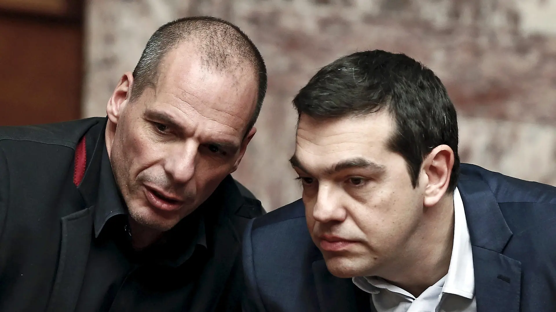 Greek Prime Minister Alexis Tsipras (R) and Finance Minister Yanis Varoufakis talk during the first round of a presidential vote at the Greek parliament in Athens, Greece in this February 18, 2015 file photo. To match Special Report EUROZONE-GREECE/TSIPRAS REUTERS/Alkis Konstantinidis/Files