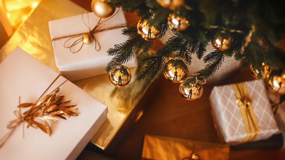 Lovely christmas tree with beautifuly packed presents and boxes under it