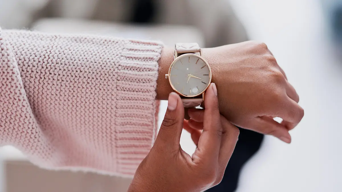 Cropped shot of an unecognizable female customer checking the time waiting for a delivery
