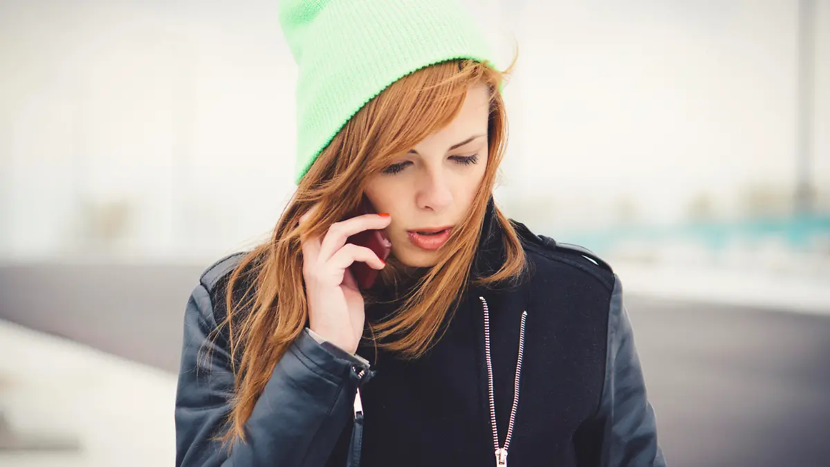 Frau telefoniert im Winter