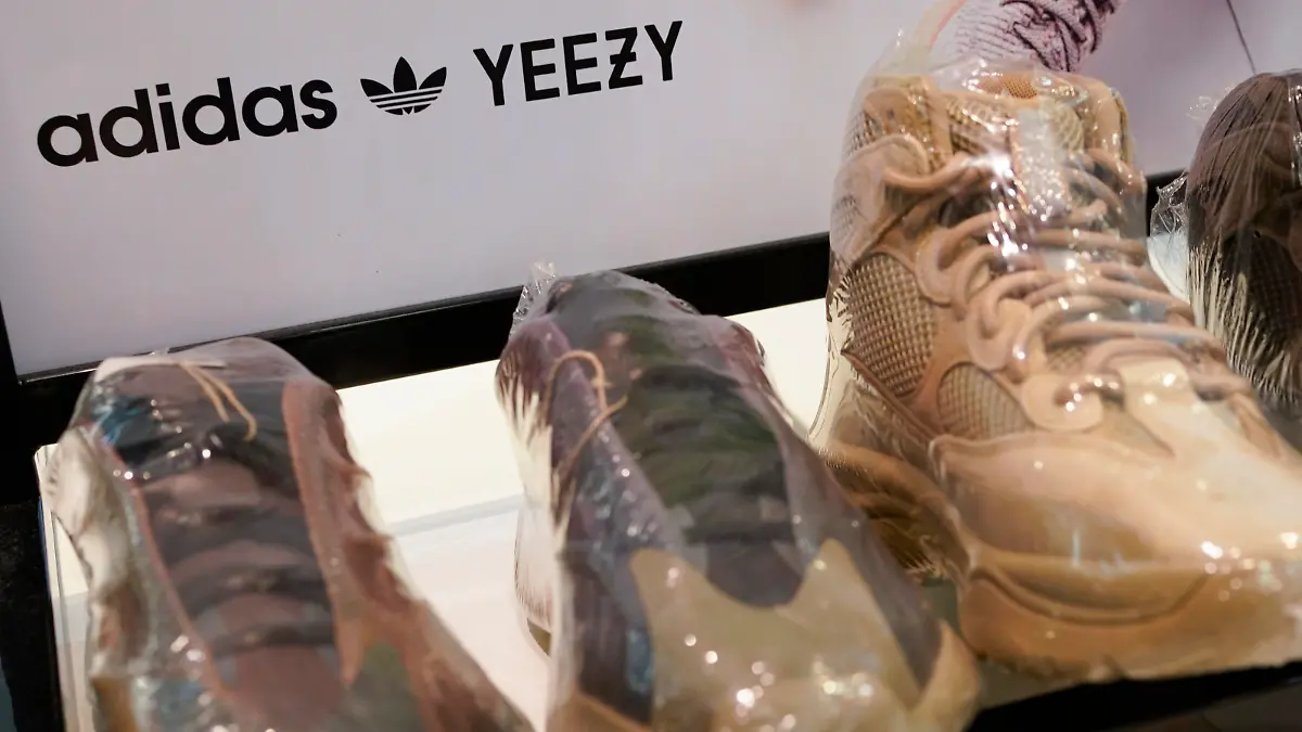A sign advertises Yeezy shoes made by Adidas at Kickclusive, a sneaker resale store, in Paramus, N.J., Tuesday, Oct. 25, 2022. Adidas has ended its partnership with the rapper formerly known as Kanye West over his offensive and antisemitic remarks, the latest company to cut ties with Ye and a decision that the German sportswear company said would hit its bottom line. (AP Photo/Seth Wenig)