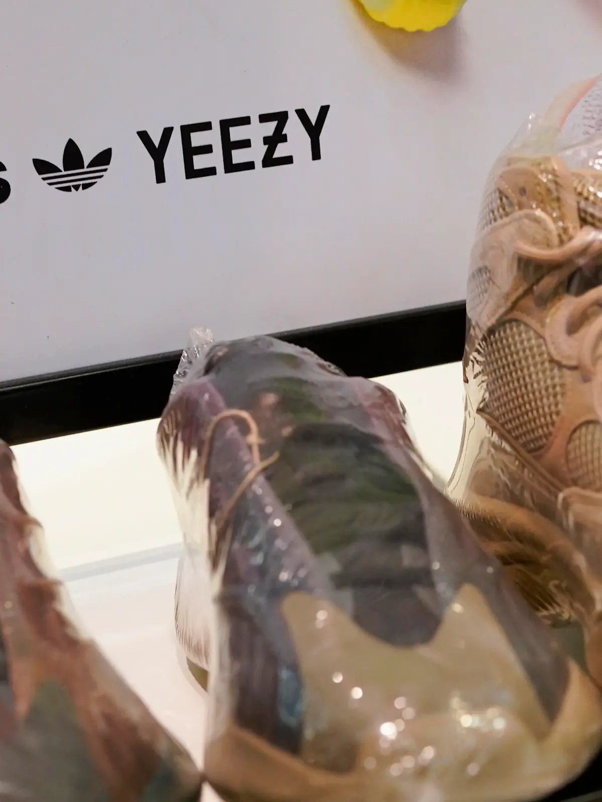 A sign advertises Yeezy shoes made by Adidas at Kickclusive, a sneaker resale store, in Paramus, N.J., Tuesday, Oct. 25, 2022. Adidas has ended its partnership with the rapper formerly known as Kanye West over his offensive and antisemitic remarks, the latest company to cut ties with Ye and a decision that the German sportswear company said would hit its bottom line. (AP Photo/Seth Wenig)