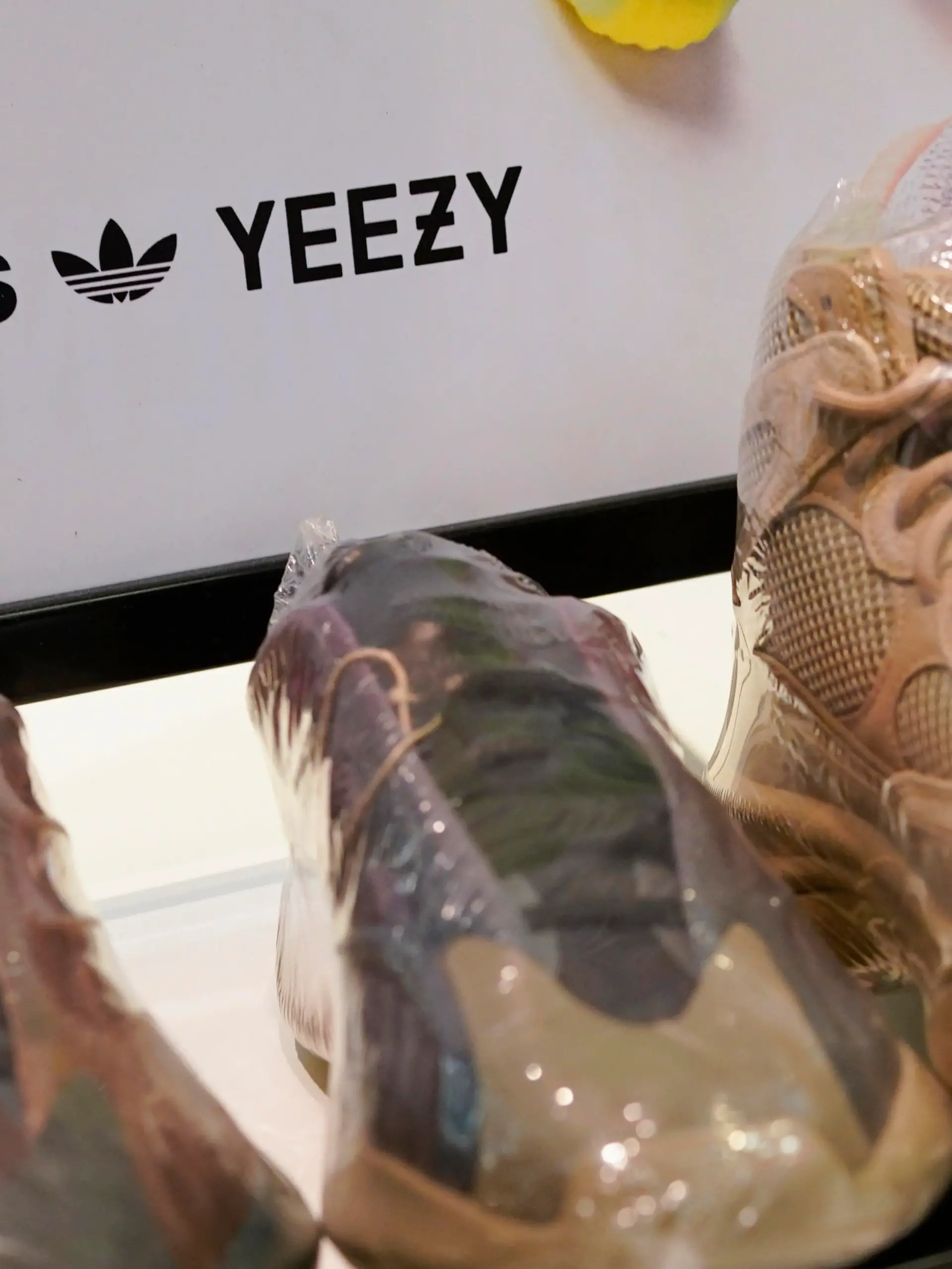 A sign advertises Yeezy shoes made by Adidas at Kickclusive, a sneaker resale store, in Paramus, N.J., Tuesday, Oct. 25, 2022. Adidas has ended its partnership with the rapper formerly known as Kanye West over his offensive and antisemitic remarks, the latest company to cut ties with Ye and a decision that the German sportswear company said would hit its bottom line. (AP Photo/Seth Wenig)