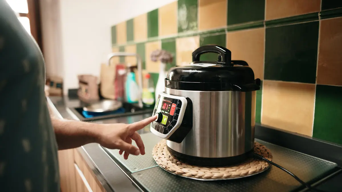 A hand programming an automatic pot
