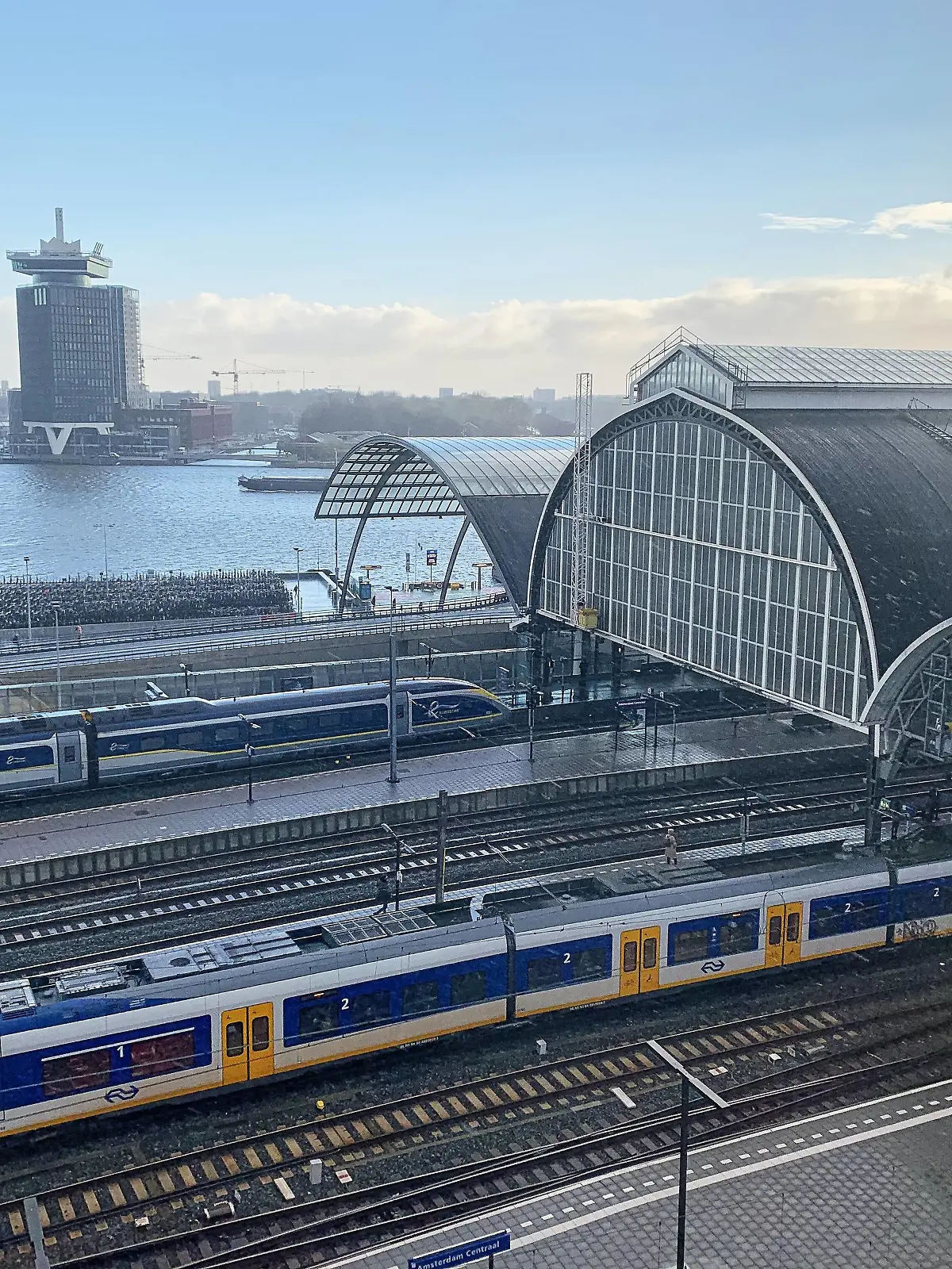 Main railway station with a Eurostar high speed train, Eye Film Museum and A DAM Lookout Restaurant in Amsterdam, Netherlands, March 25, 2019. Photographer: Peter Schatz  