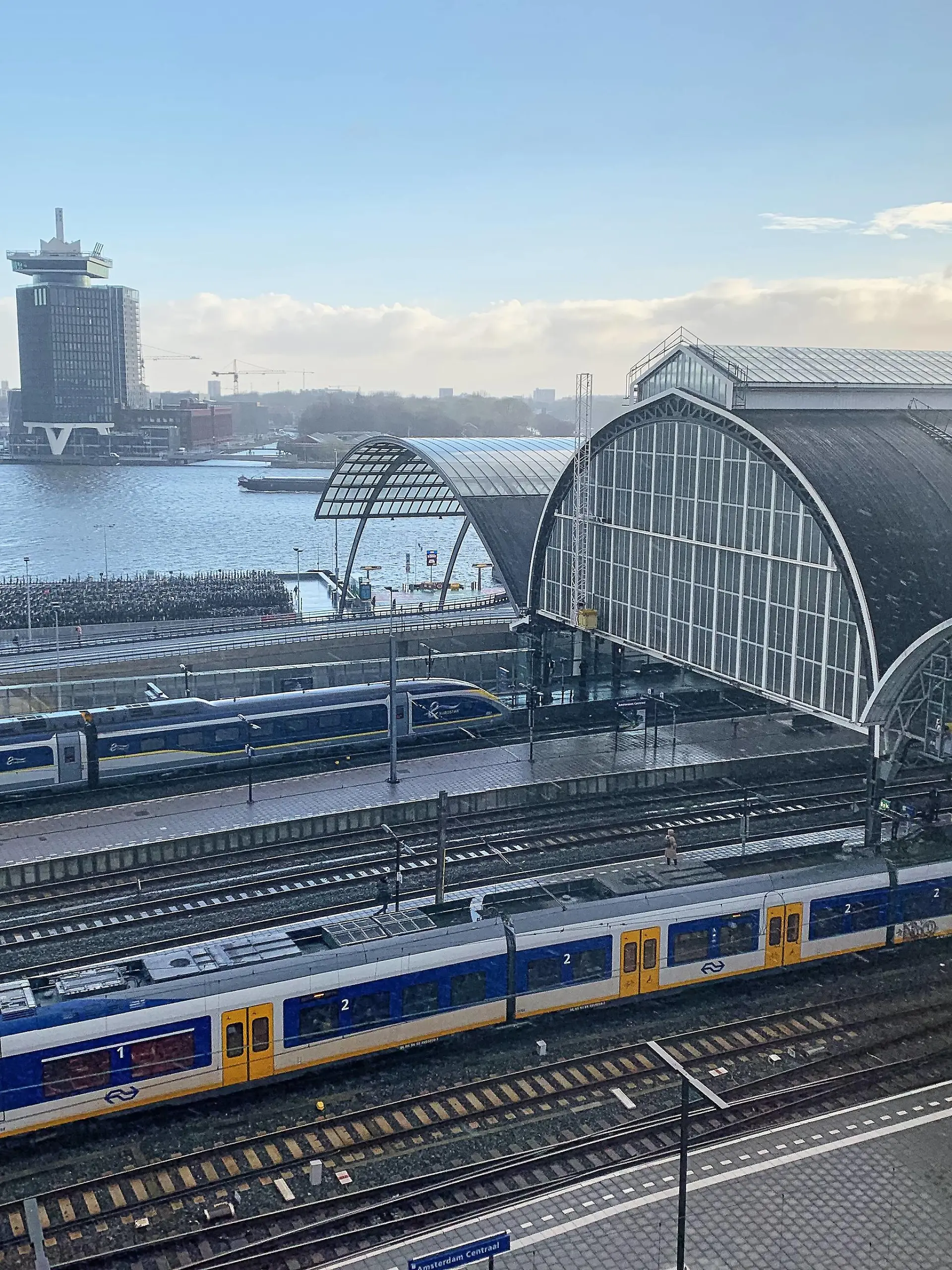 Main railway station with a Eurostar high speed train, Eye Film Museum and A DAM Lookout Restaurant in Amsterdam, Netherlands, March 25, 2019. Photographer: Peter Schatz  