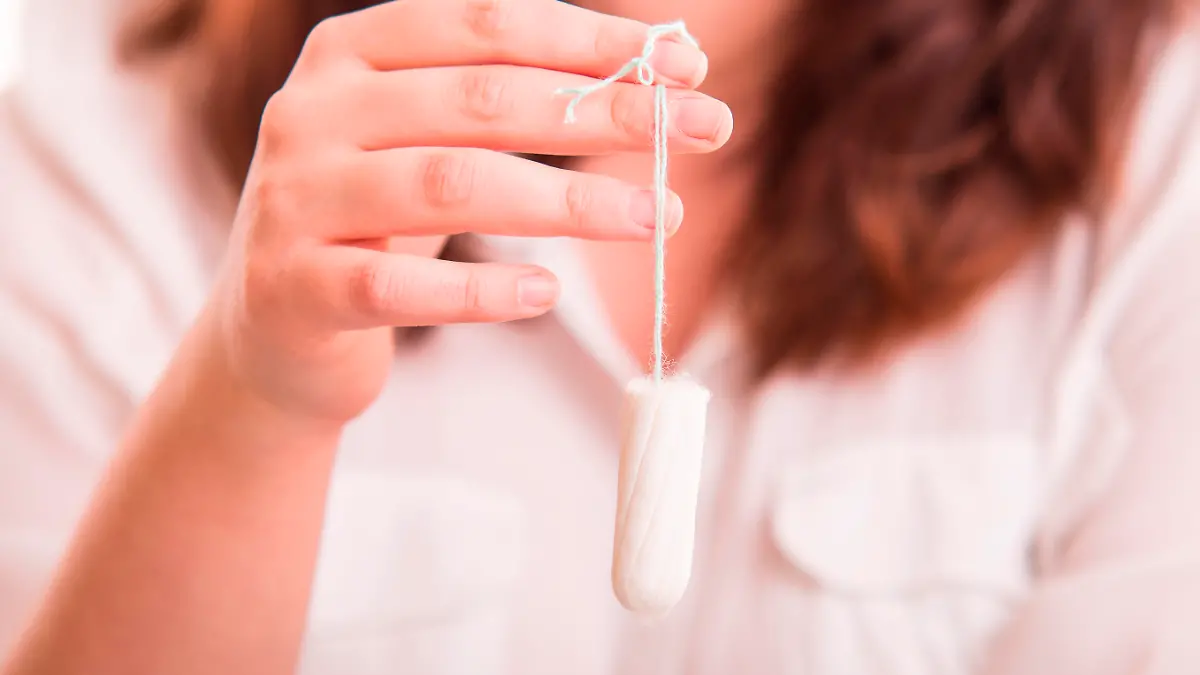 Vaginal Tapopon in woman's hand - studio shot