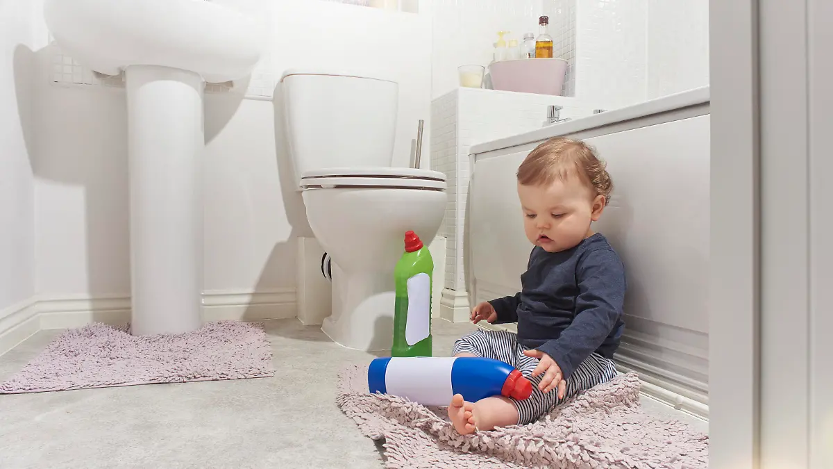 Baby boy finds bleach and other cleaning products not put out of harms reach in the bathroom while his parents are distracted.